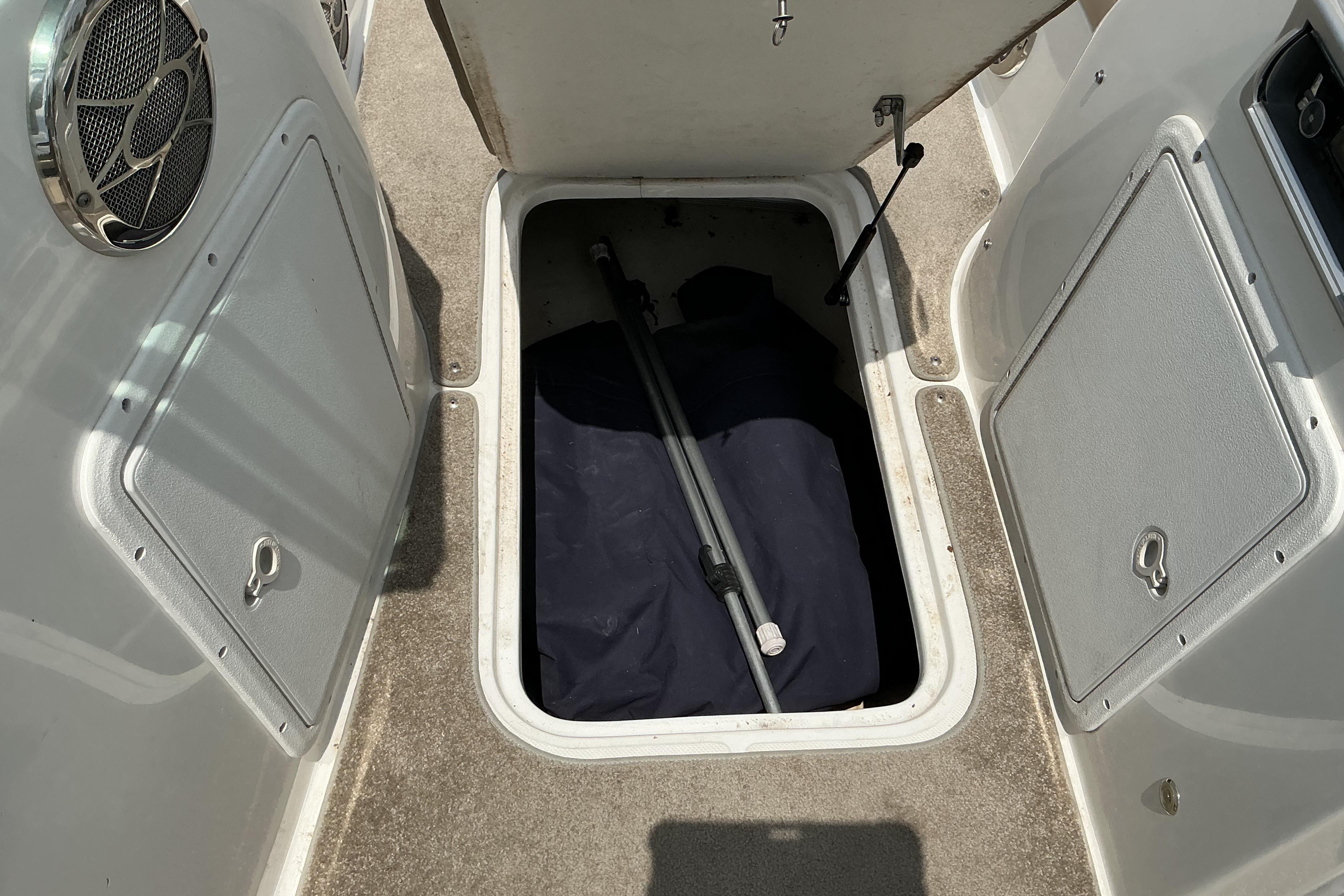 2015 Hurricane SunDeck 187 IO boat storage compartment with open hatch and visible equipment.