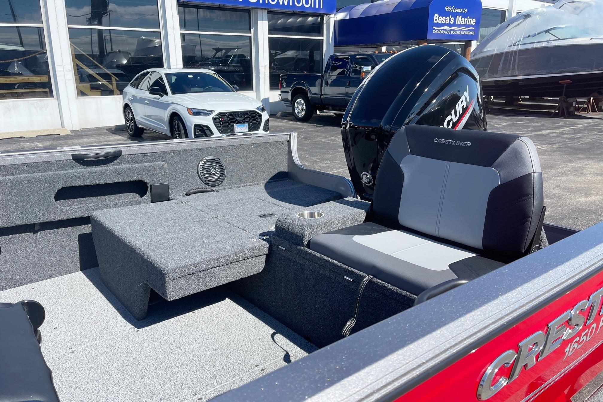 2023 Crestliner 1650 Fish Hawk boat interior with seating and Mercury engine at dealership.