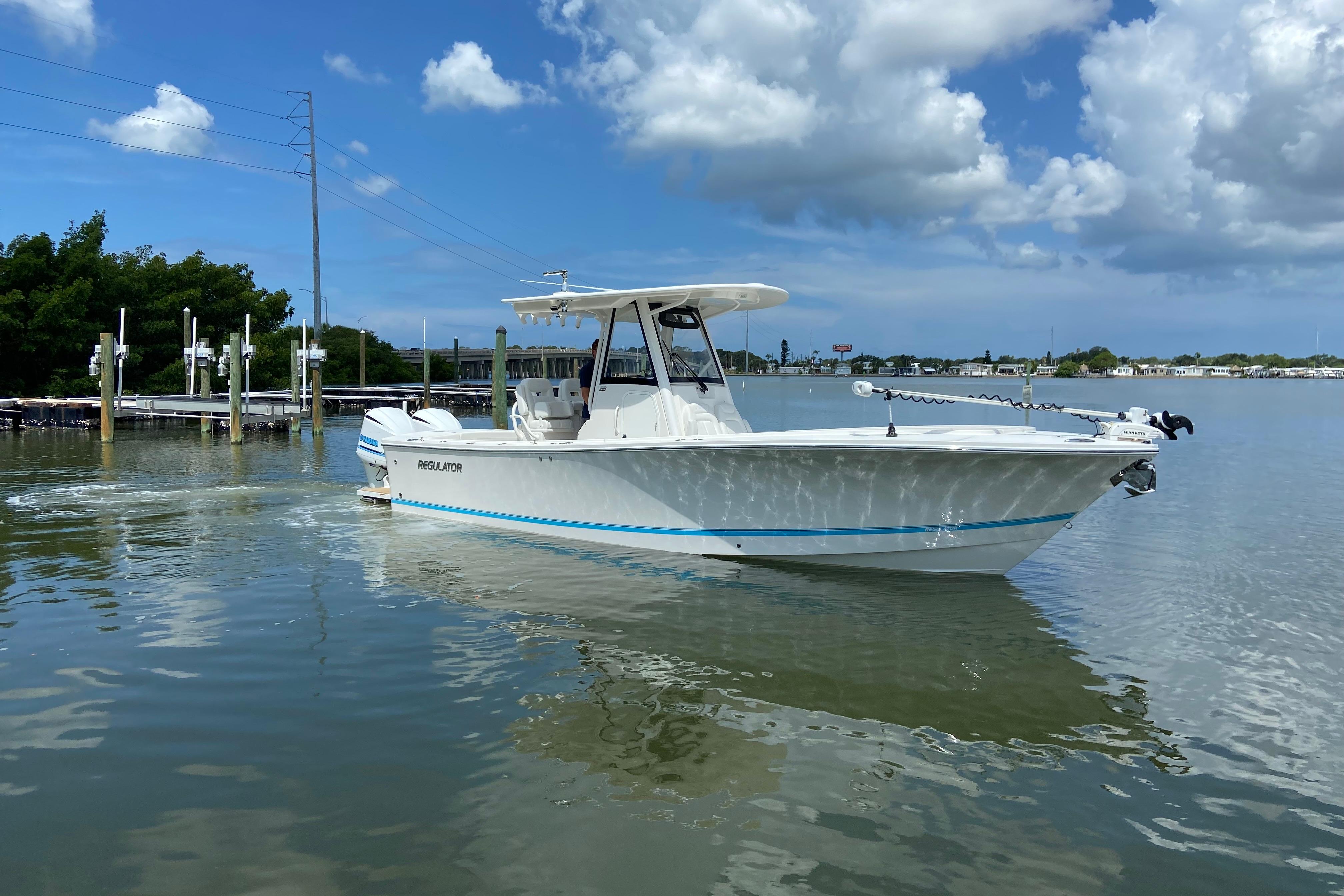 2021 Regulator 28 boat on calm water under a partly cloudy sky.