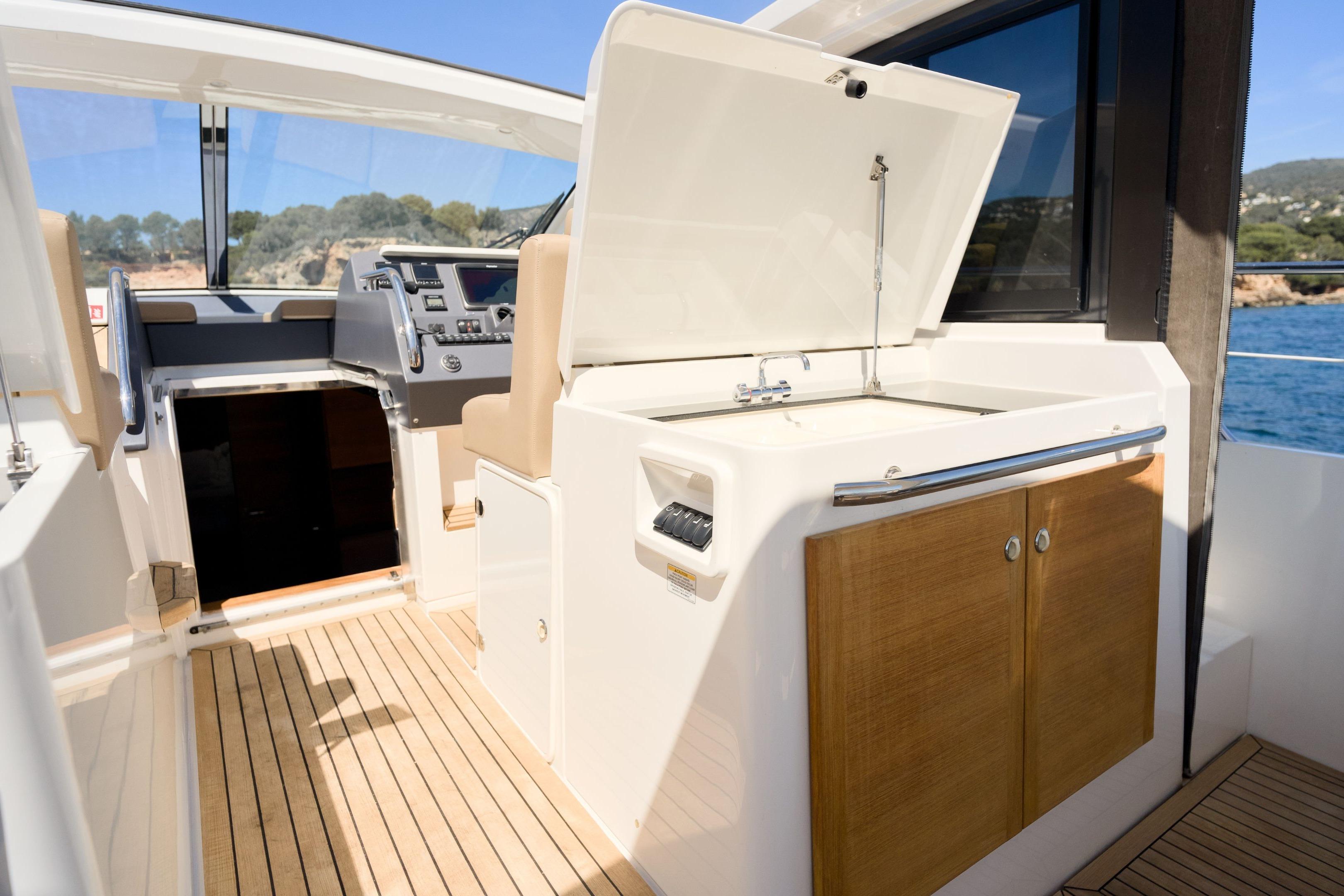 2012 Sealine SC42 yacht interior with helm, cabinetry, and open hatch.
