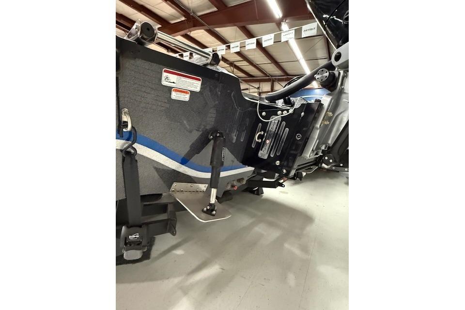 2024 Nitro ZV21 boat hull with blue stripe in a warehouse setting.