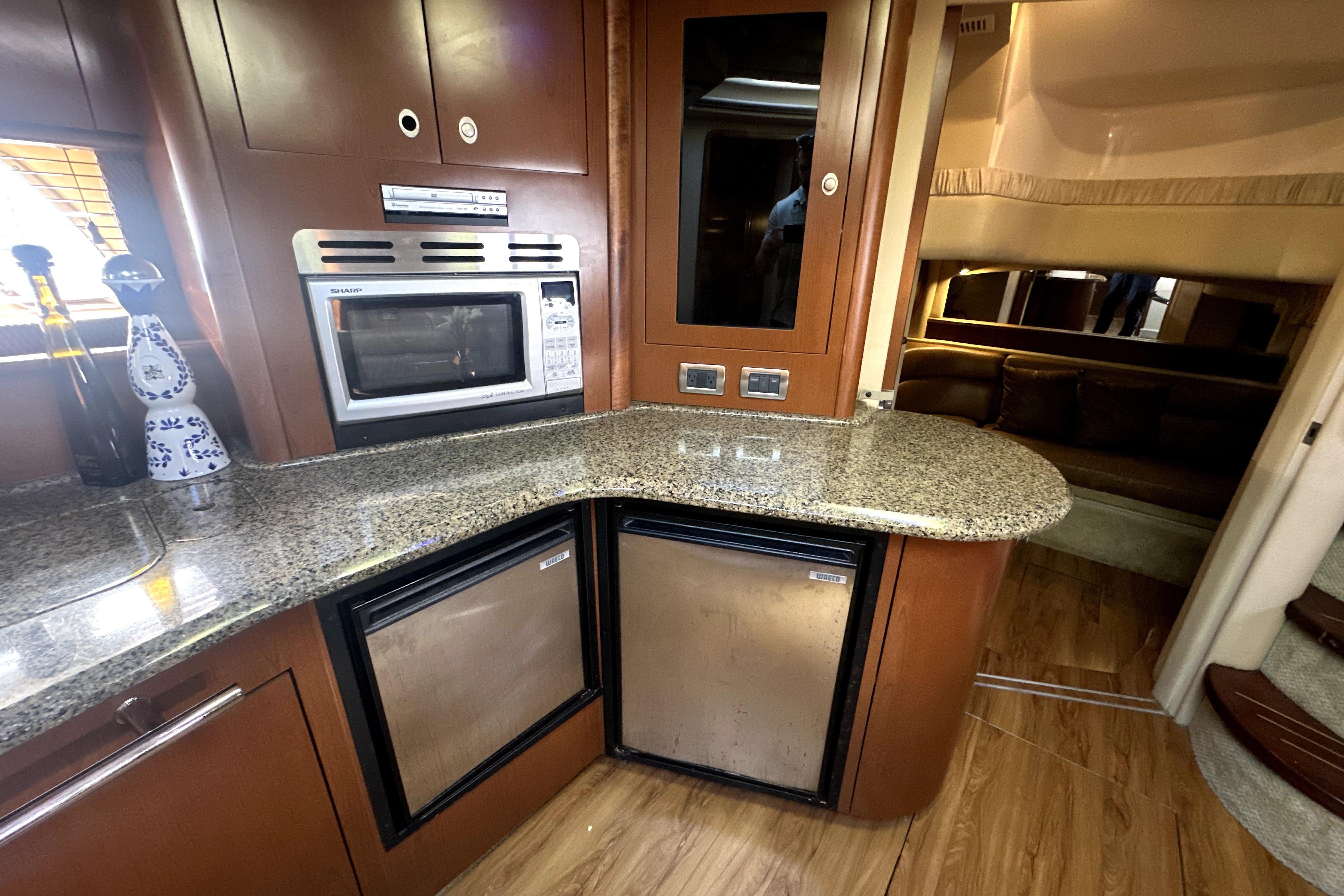 Luxurious 2007 Sea Ray 44 Sundancer yacht interior with modern kitchen amenities.