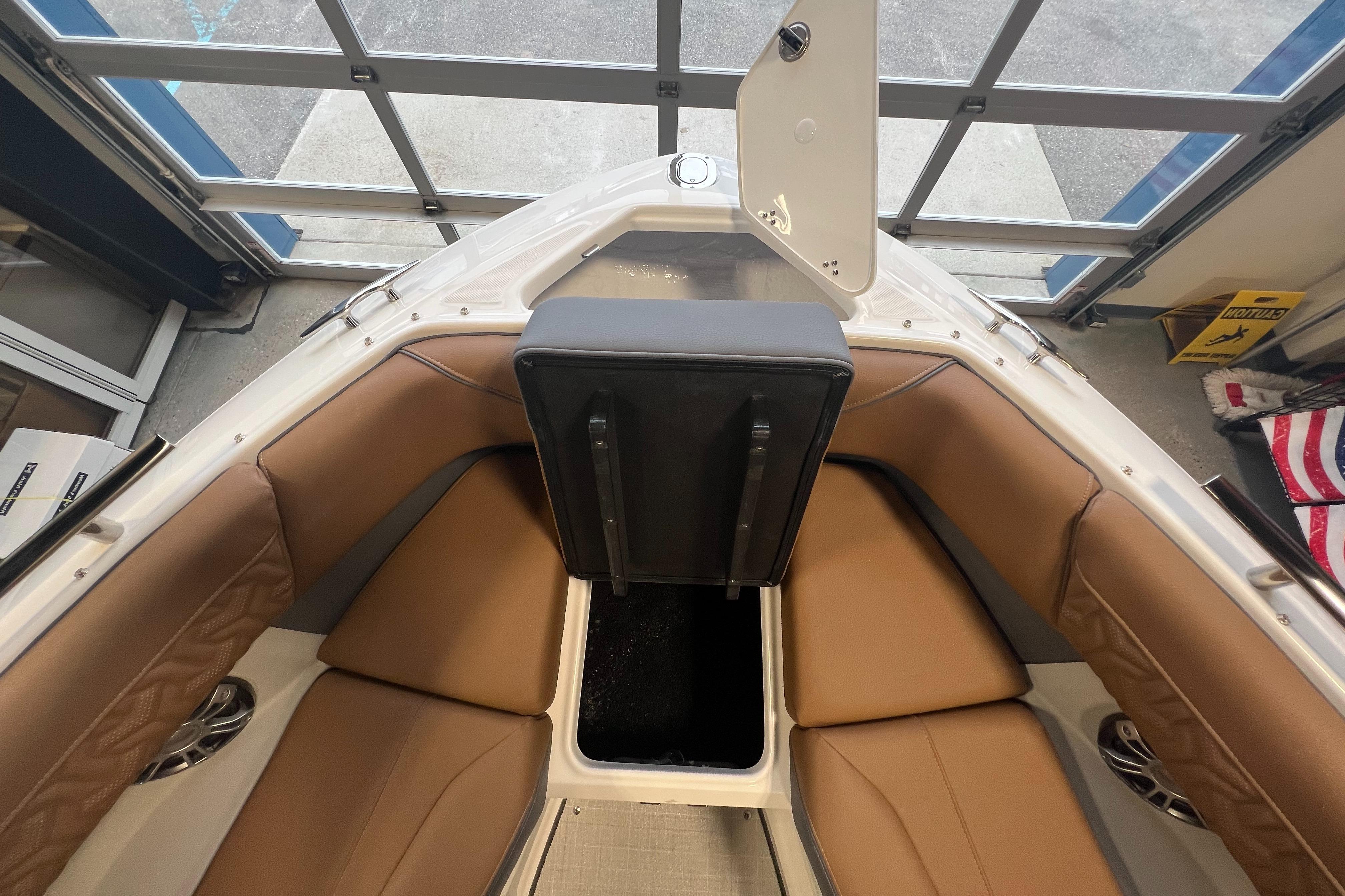 2025 Regal LS4 boat interior with tan seating and storage compartment.