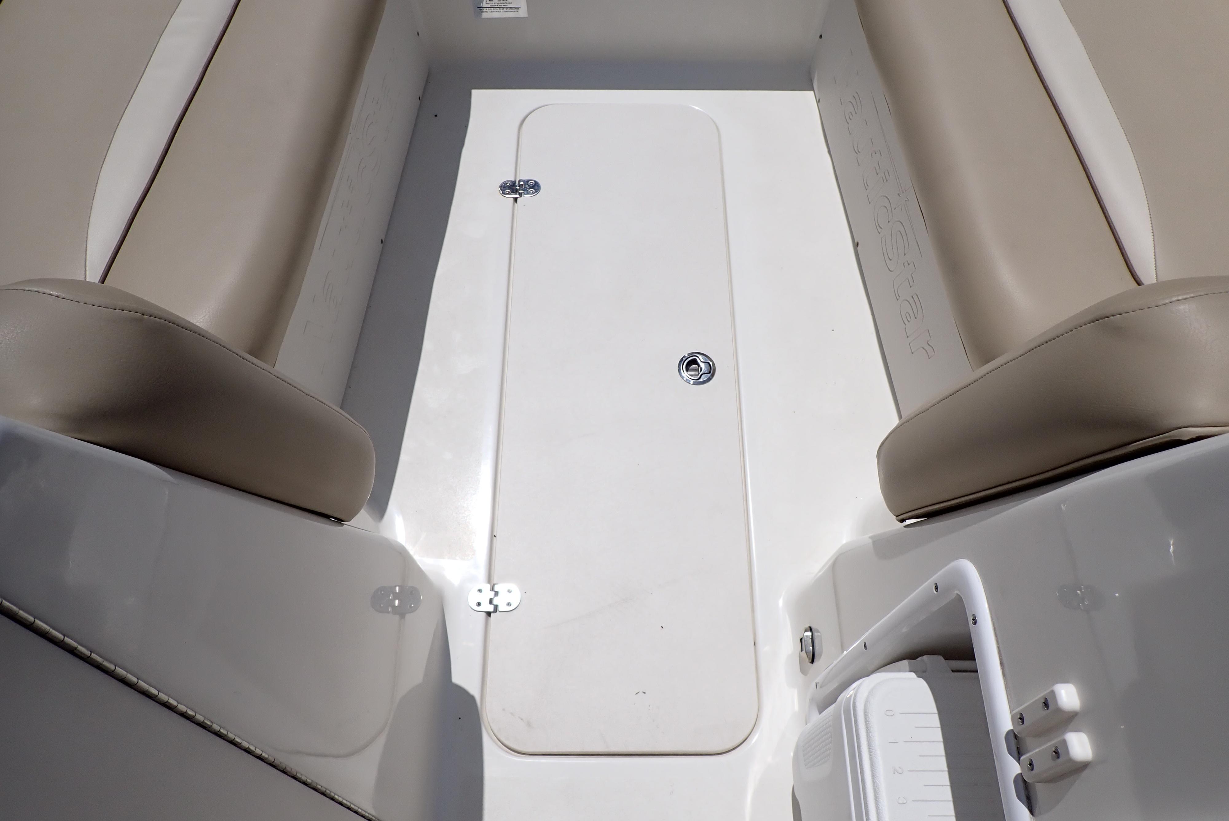 2021 NauticStar 223 DC boat interior with beige seating and storage compartment.