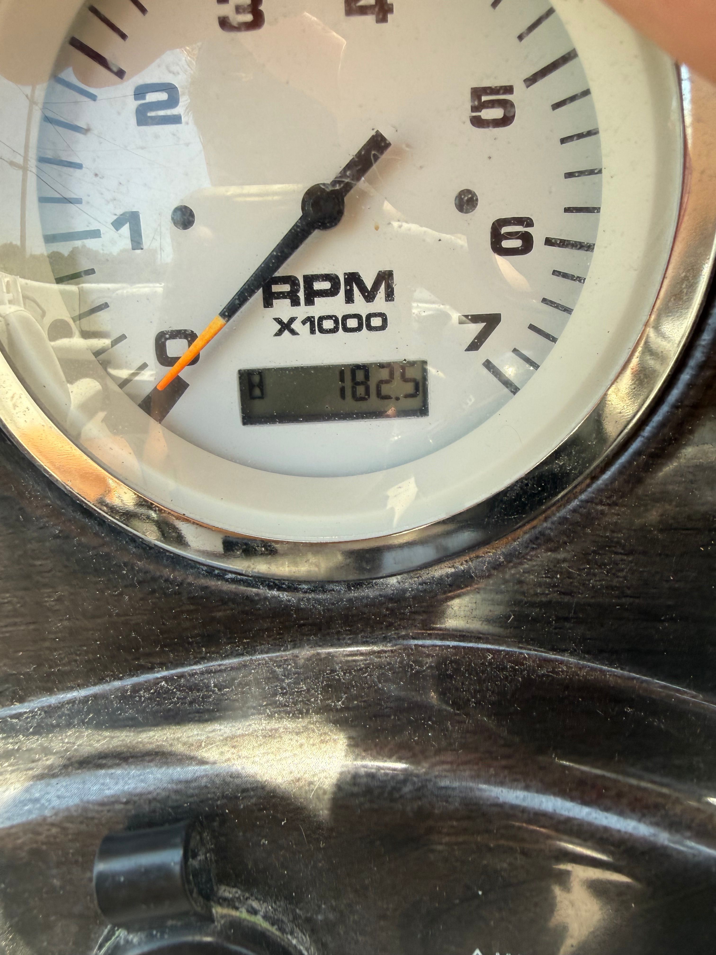 Close-up of a tachometer showing 1825 RPM.