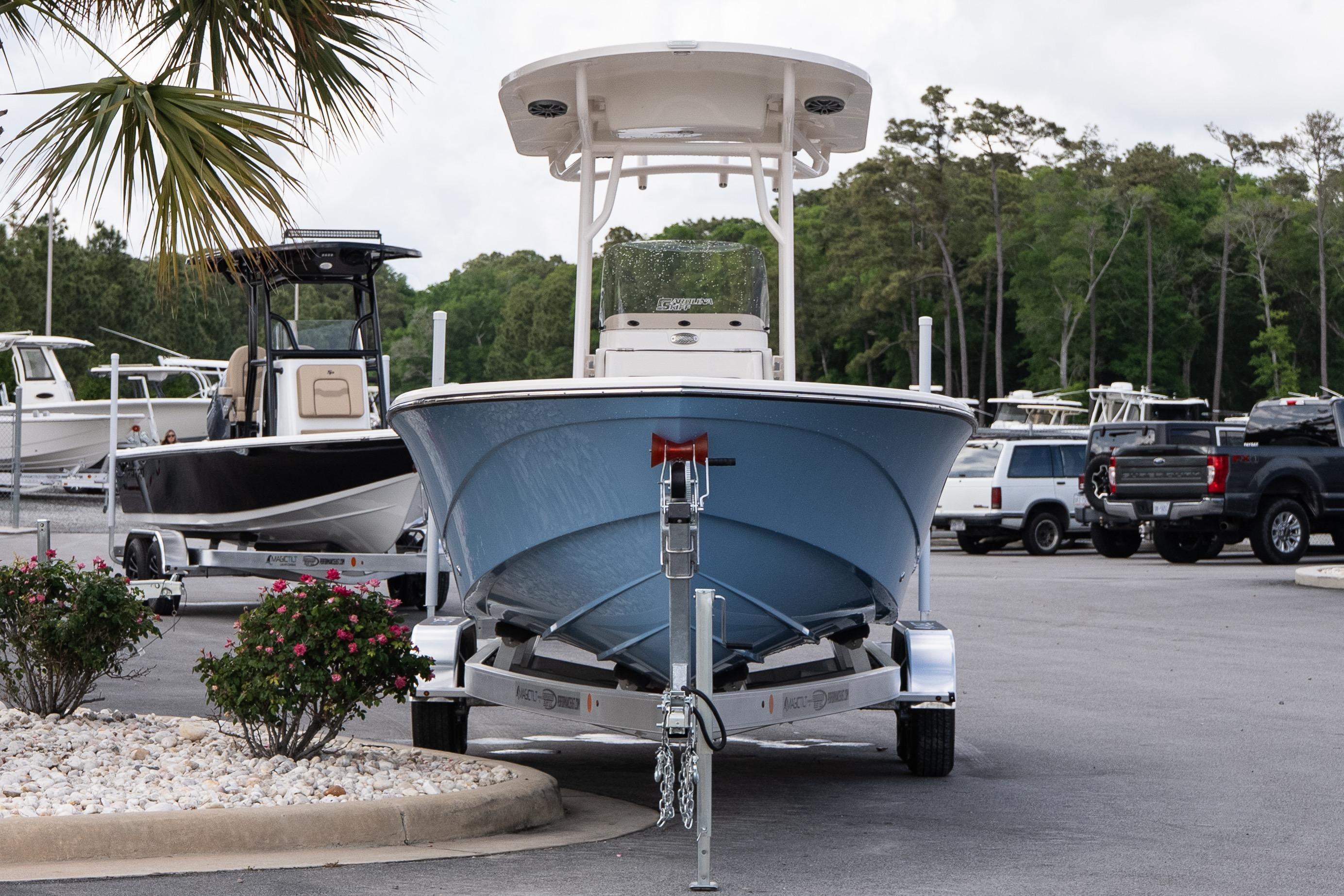 2026 Carolina Skiff 24 Ultra Elite boat on trailer in parking lot.