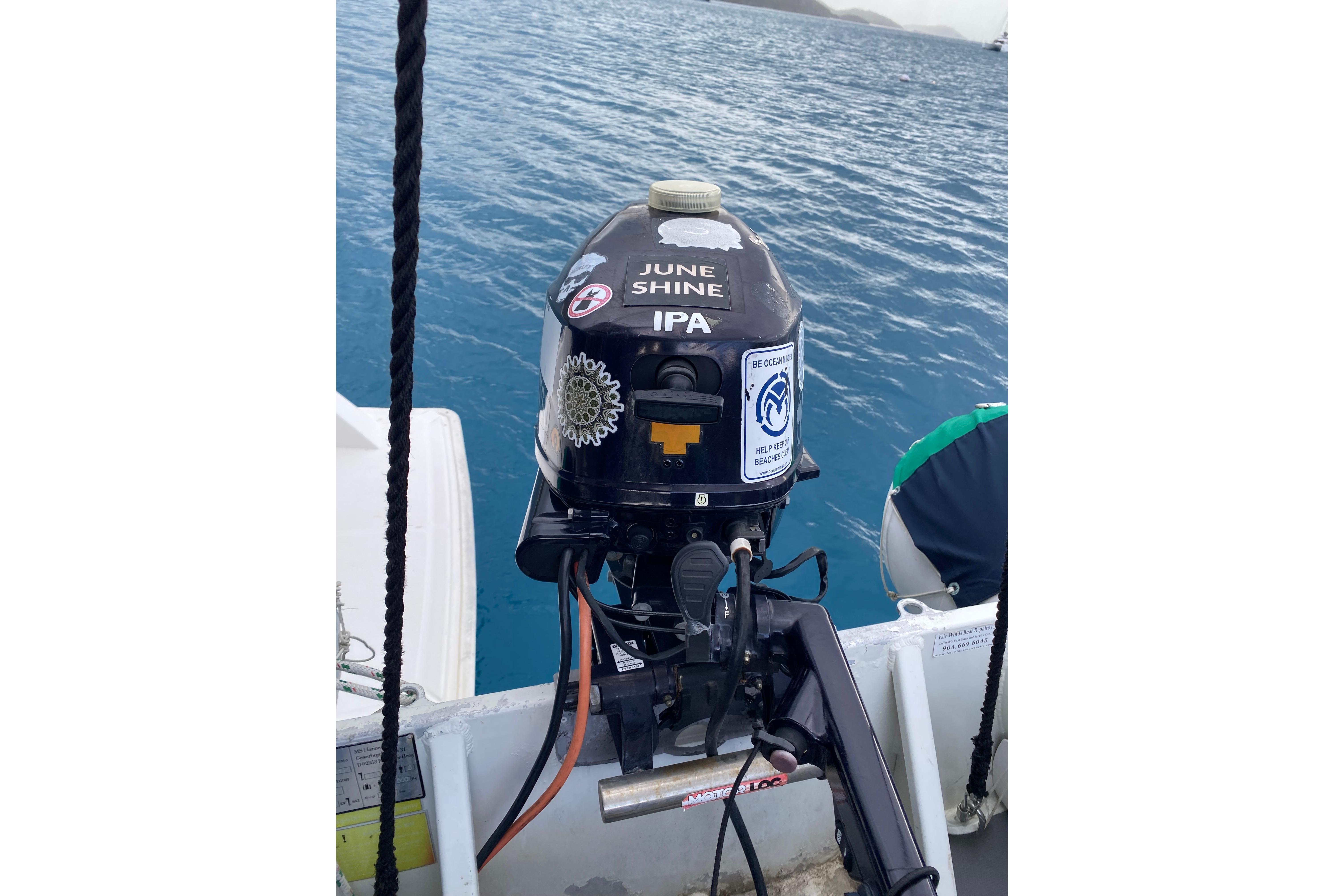 Outboard motor with stickers on a Leopard 40 boat, 2017 model, in the ocean.