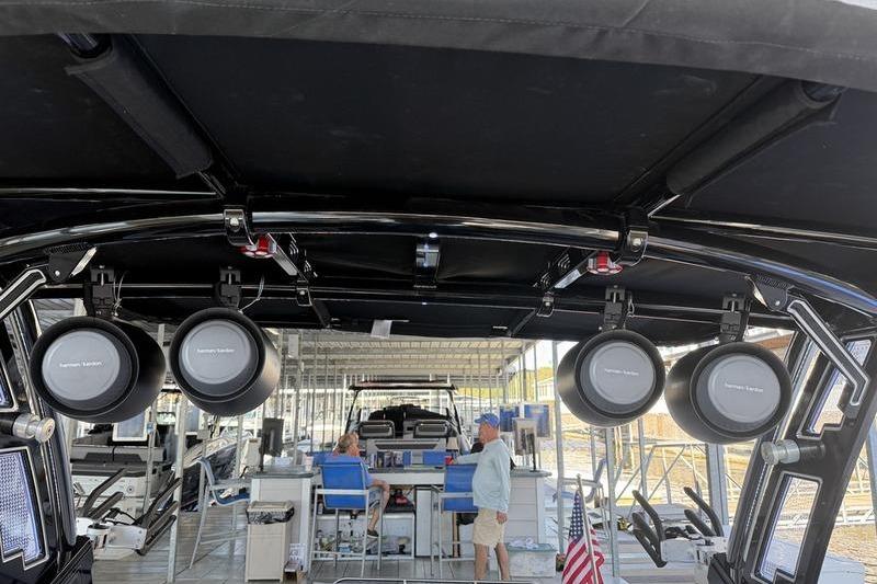 2026 Cobalt R8 Surf boat interior with speakers and dock view.