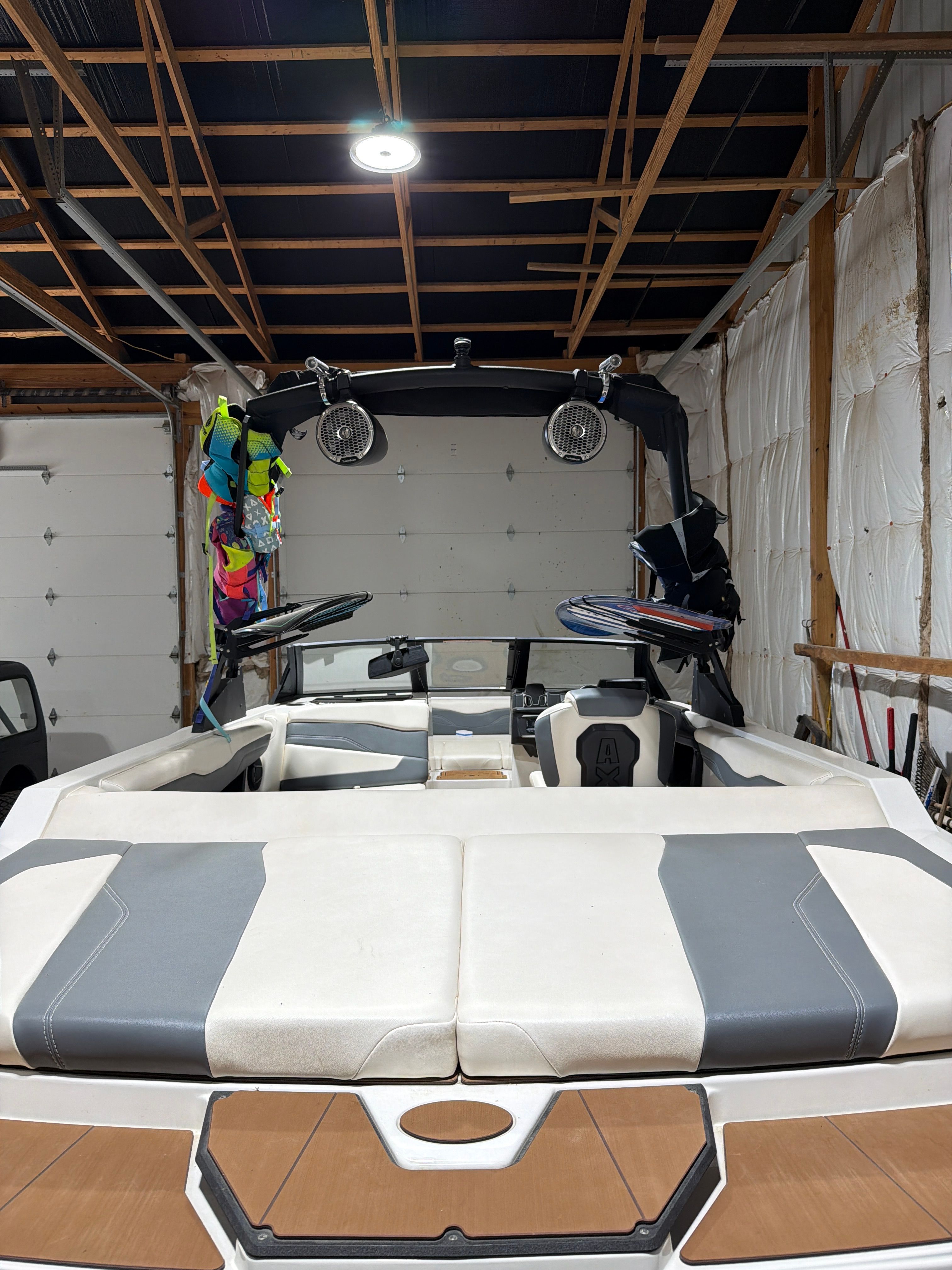 2024 Axis T220 boat in a garage with watersports gear.