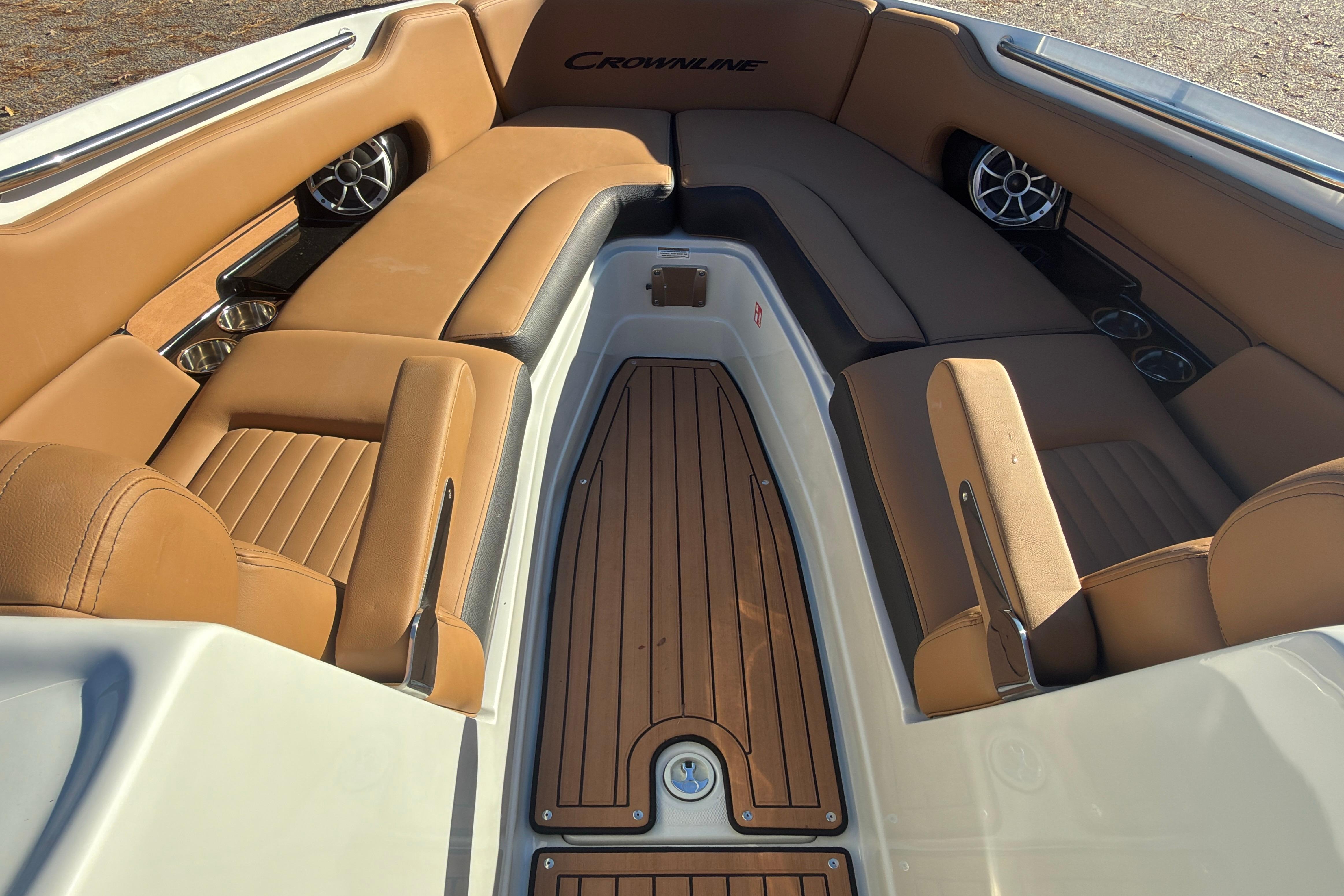 2026 Crownline 298 SS boat interior with tan leather seating and wood flooring.