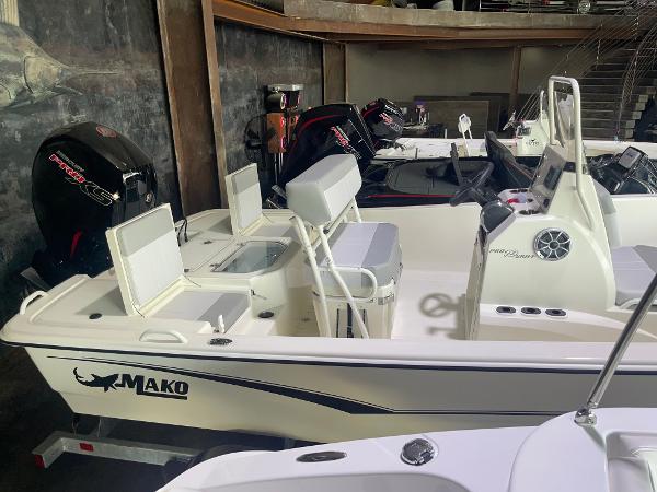 2024 Mako Pro Skiff 19 CC boat in showroom, side view.