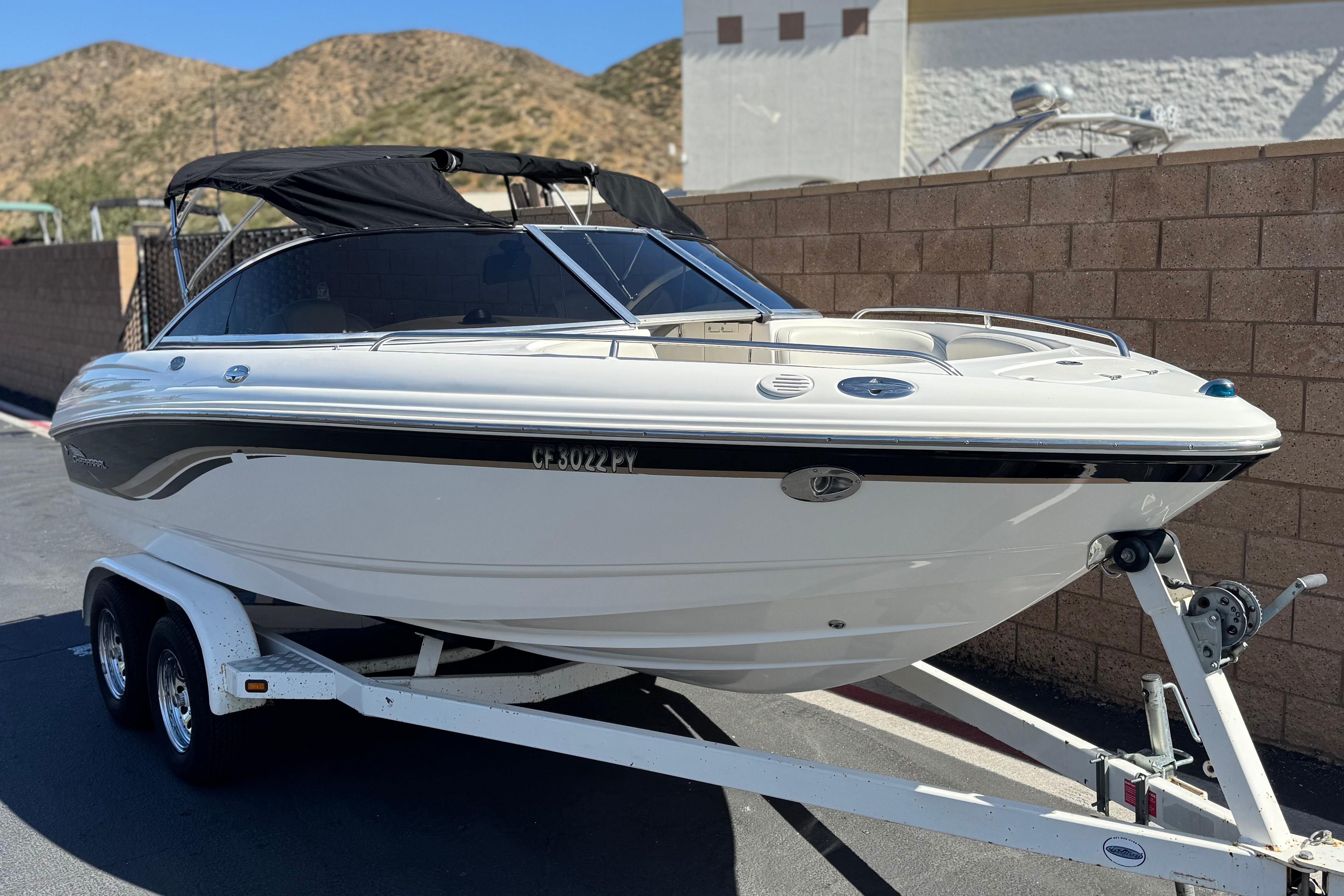 Chaparral 186 SSi 2002 boat on trailer, parked outdoors with hills in background.