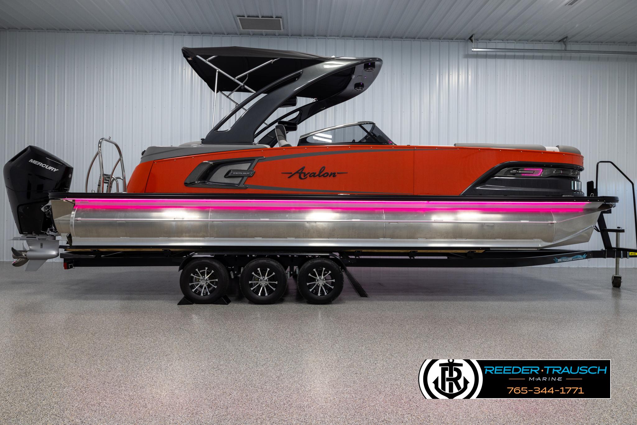 2024 Avalon 2785 Excalibur EL pontoon boat in showroom with trailer.