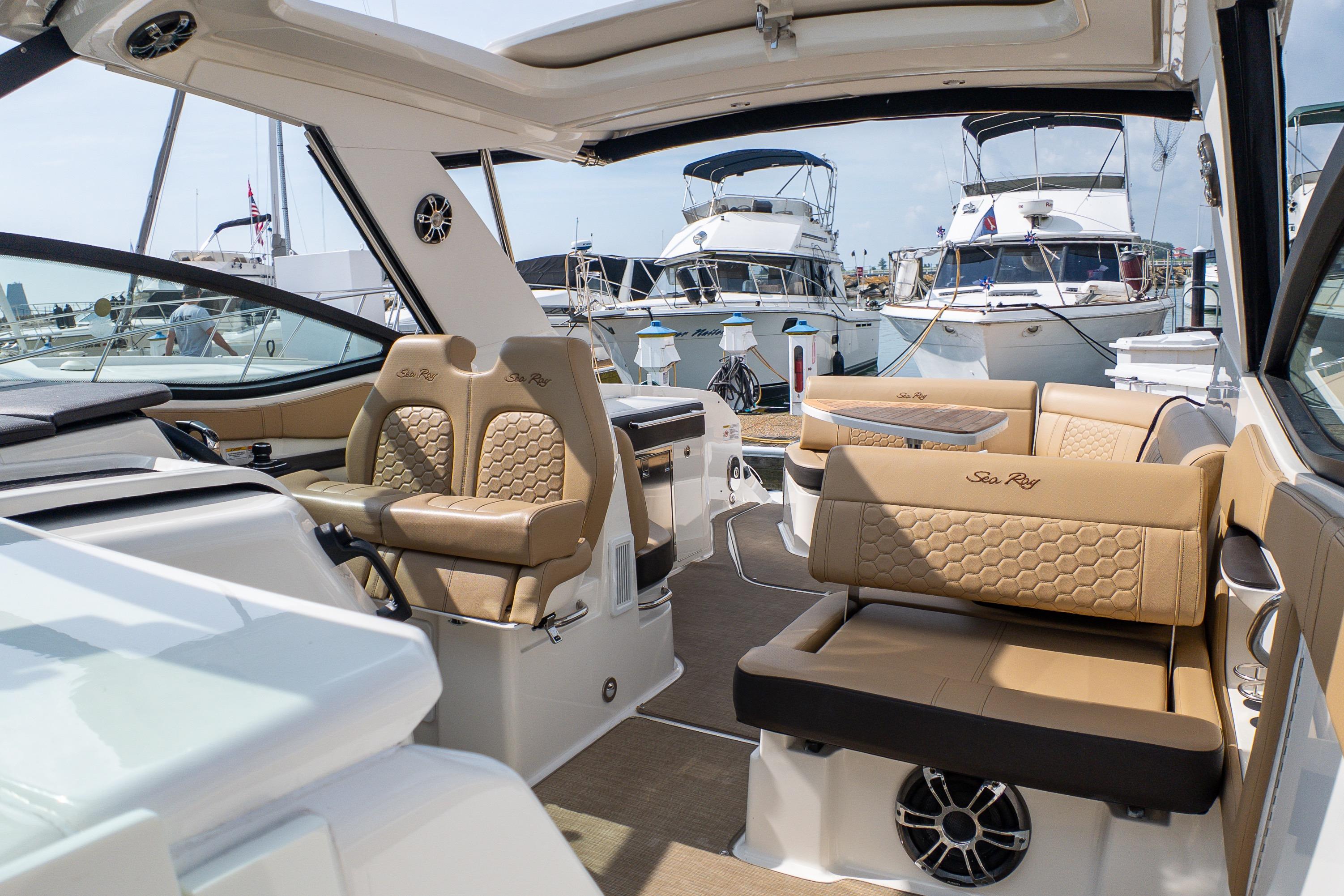 Luxurious 2019 Sea Ray Sundancer 320 yacht interior with elegant seating at marina.