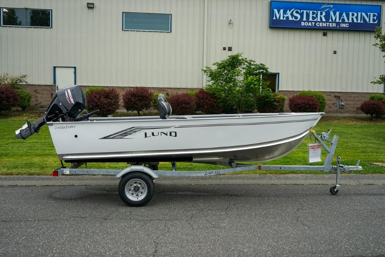 2026 Lund 1400 Fury Tiller boat on trailer outside Master Marine Boat Center.