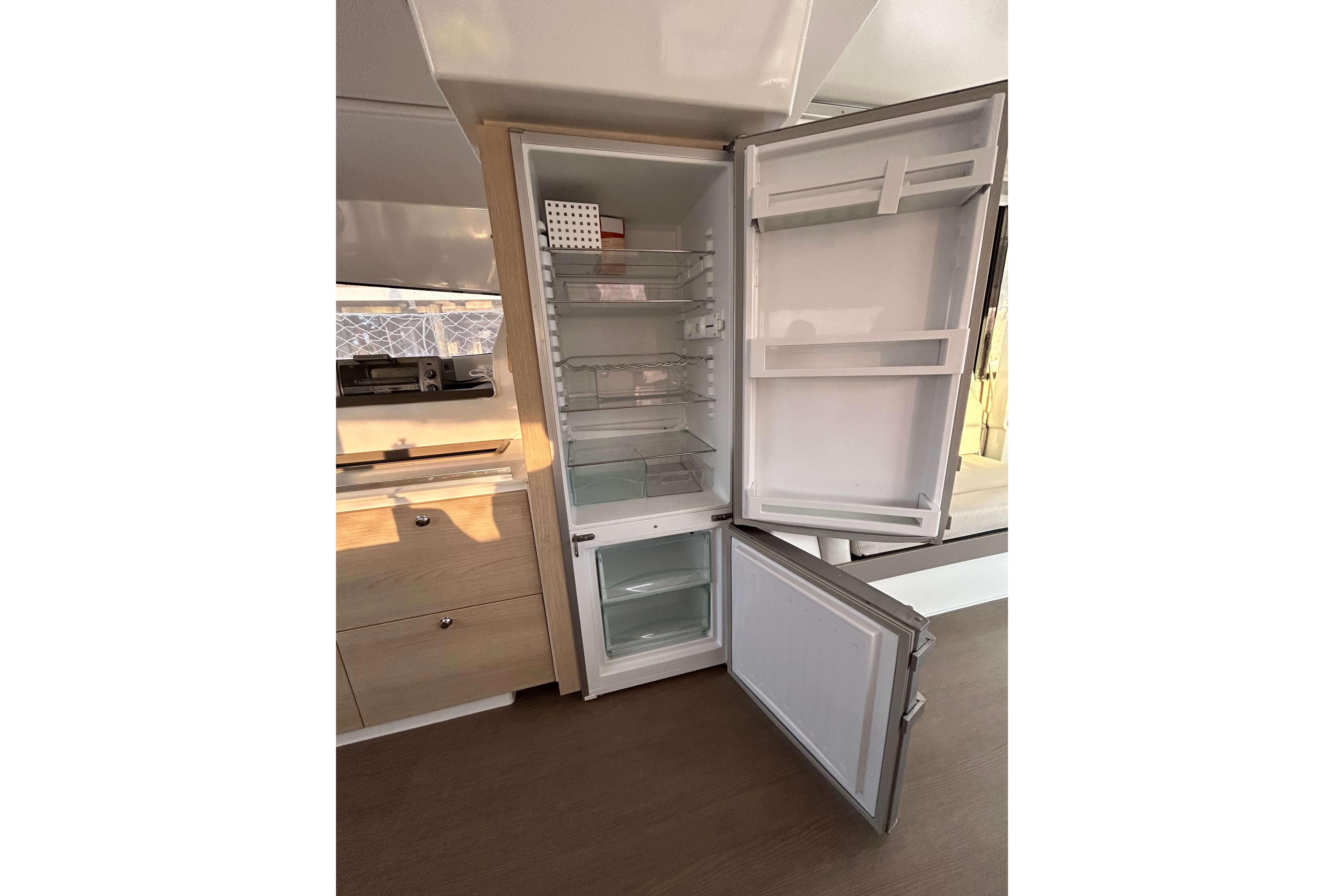 Open refrigerator in a Bali 4.1 model yacht, showcasing spacious interior shelves.