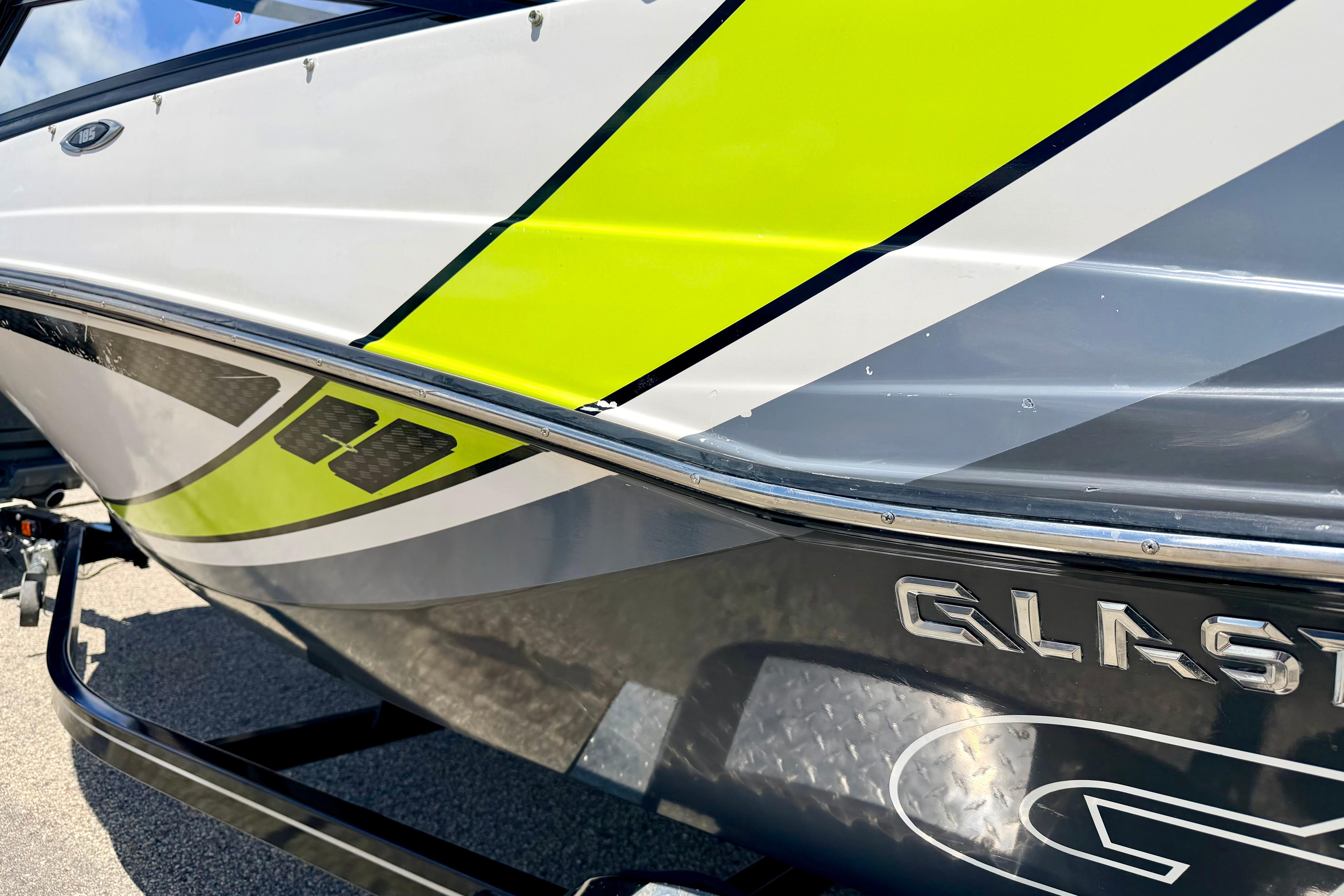2018 Glastron GT 185 boat with vibrant green and gray detailing on the hull.