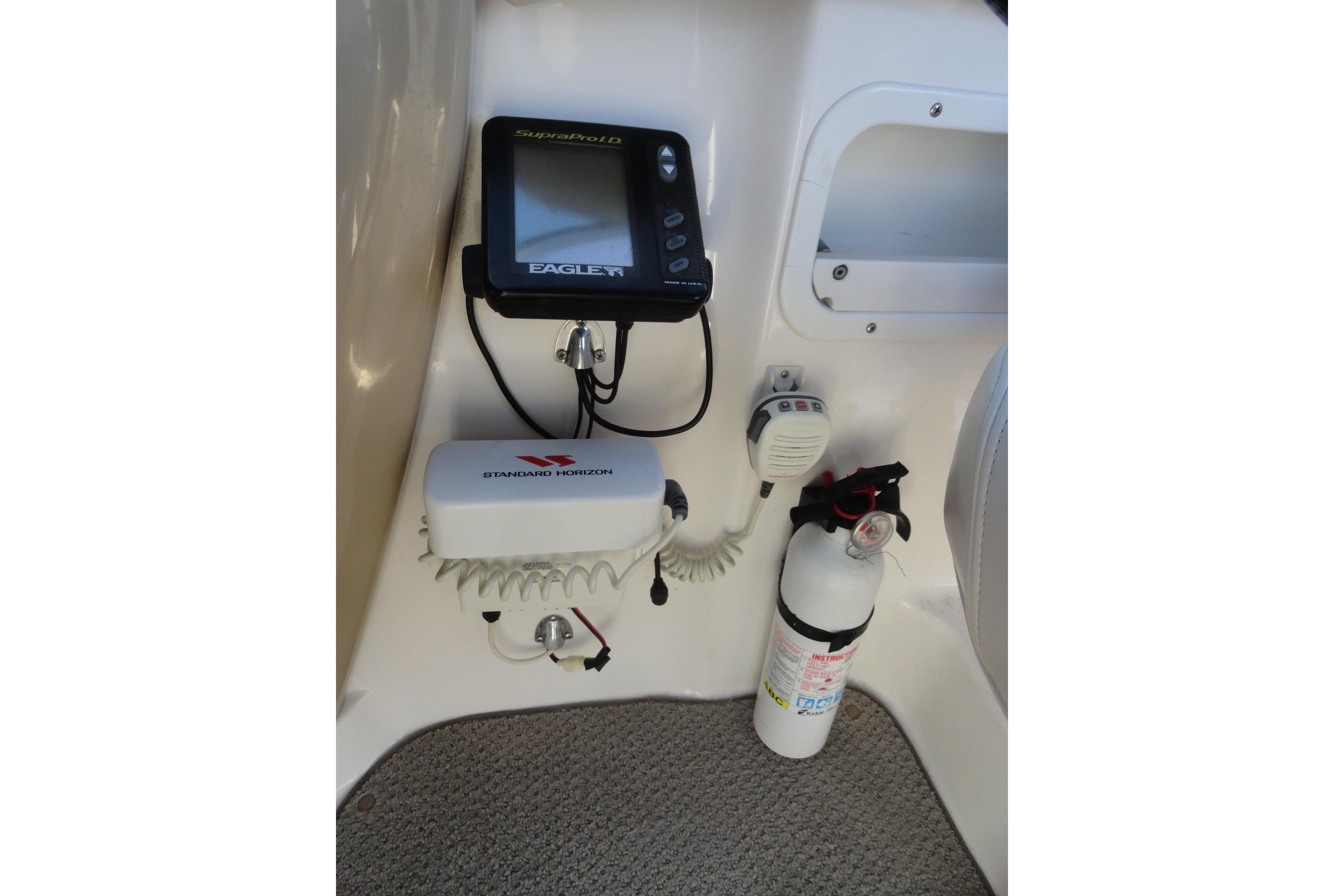 2001 Chaparral 265 SSi boat interior with navigation equipment and fire extinguisher.