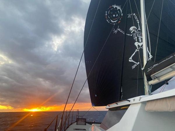 Sailing yacht Vision 444 at sunset with skeleton-themed sail, 2025 model.
