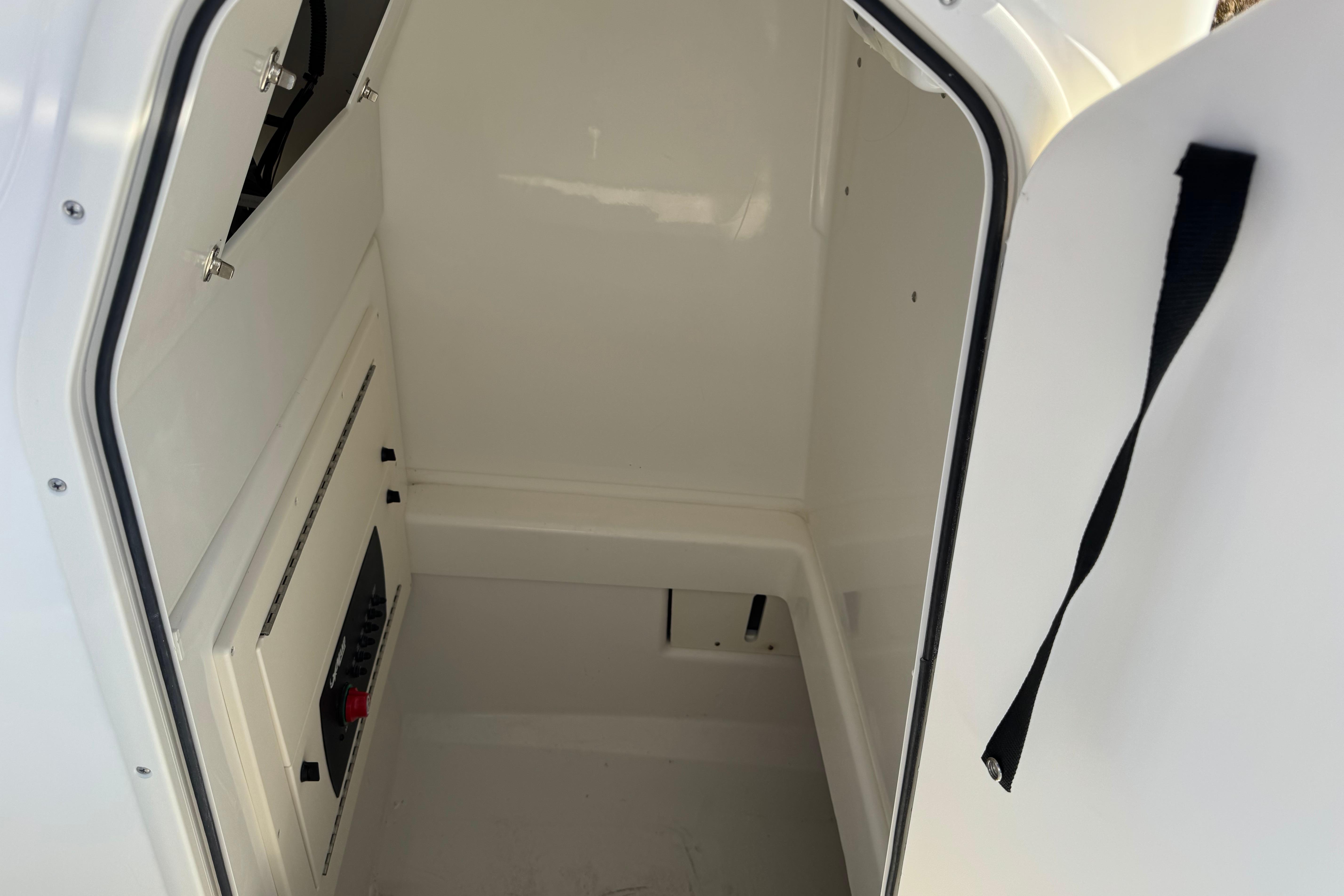 Interior view of 2026 Mako 214 Center Console boat's storage compartment.