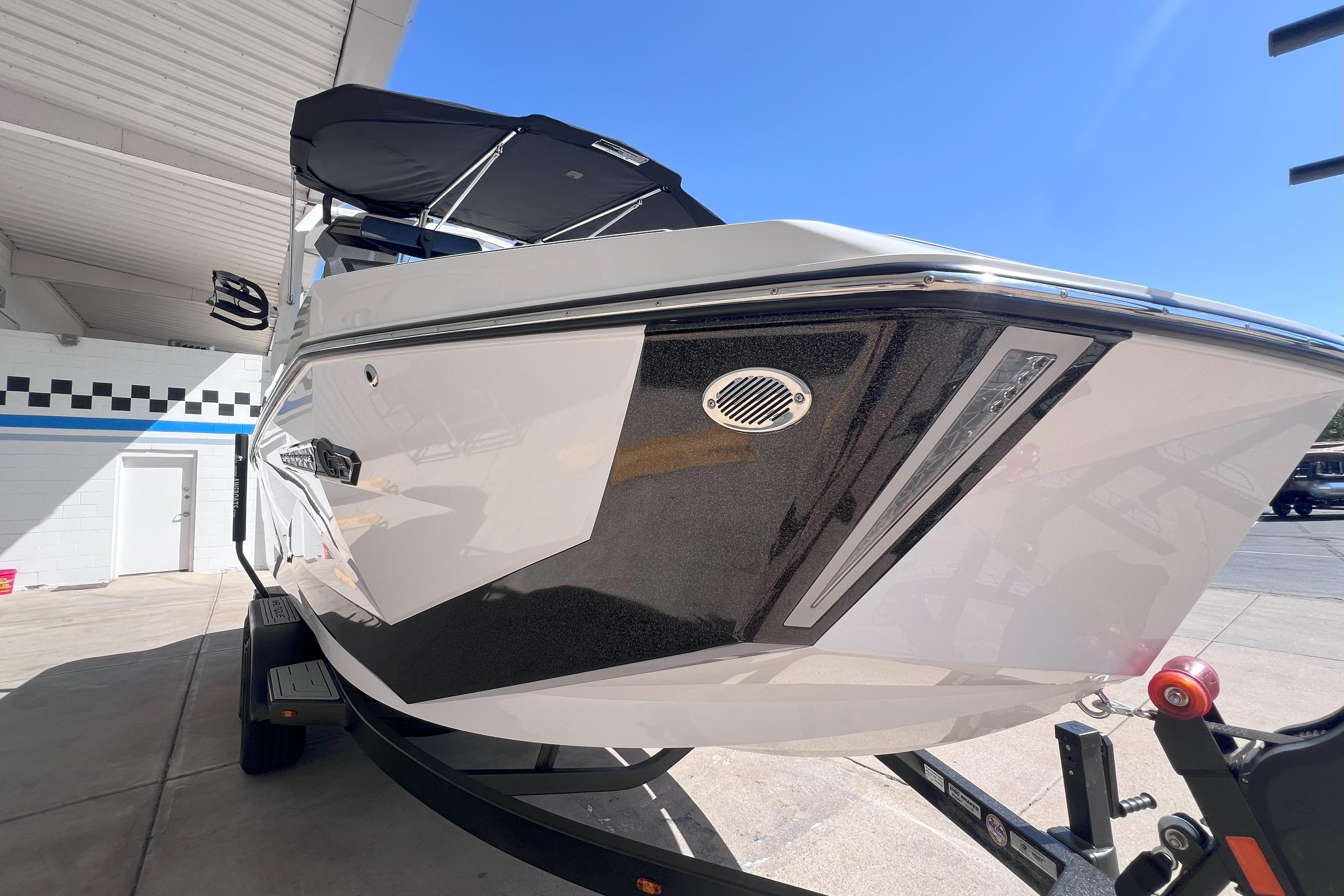 2025 Nautique Super Air Nautique G21 boat on trailer, under sunny sky.