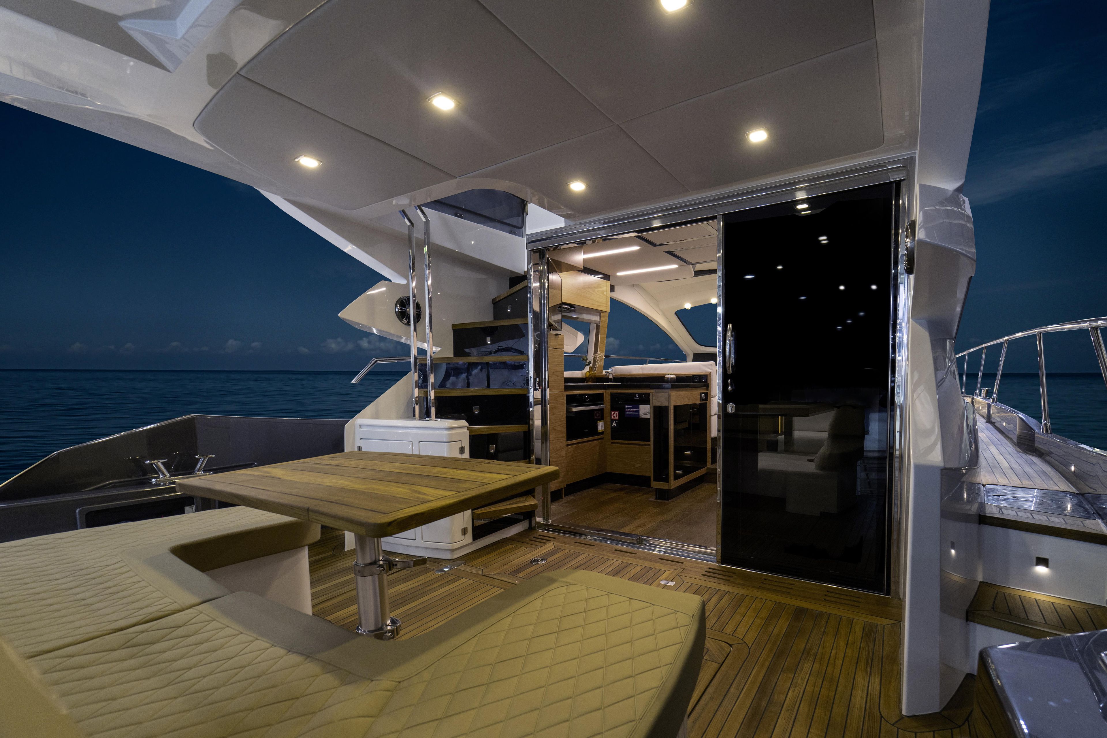 Luxurious 2025 Cobrey 52 FLY yacht interior with elegant seating and modern kitchen.