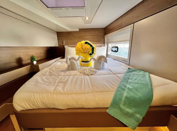 Luxurious Bali 4.6 yacht bedroom with elegant towel art and modern decor, 2023 model.