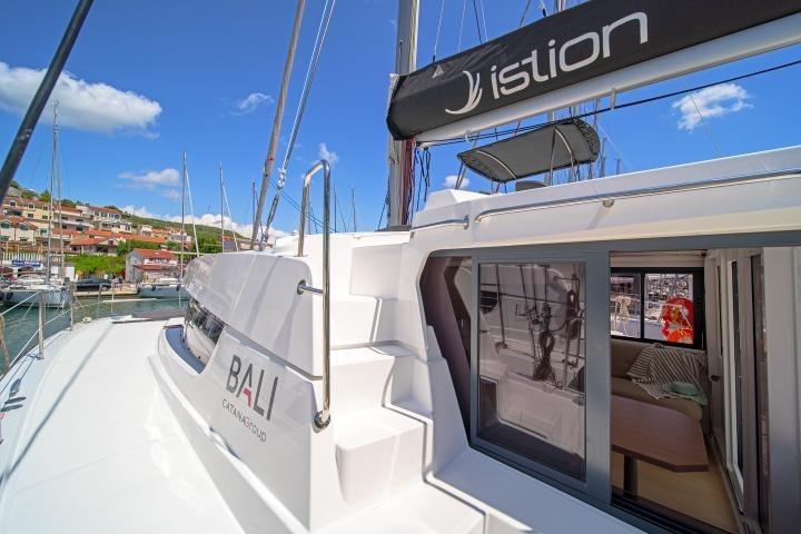 2023 Bali 4.2 catamaran docked at marina, showcasing sleek design and spacious interior.