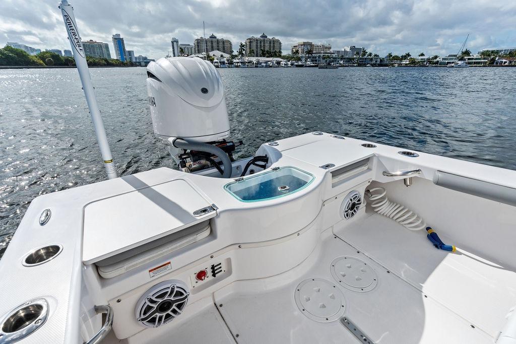 2023 Everglades 243 Center Console boat on water, featuring modern deck and engine.