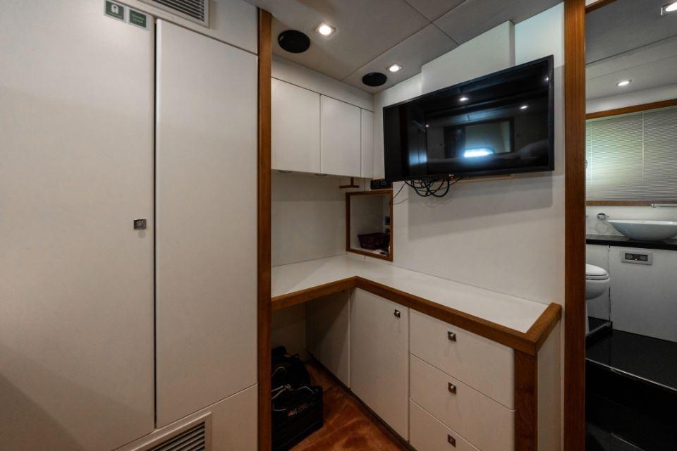Interior of 2009 Sunseeker 34 Metre Yacht with modern cabinetry and wall-mounted TV.