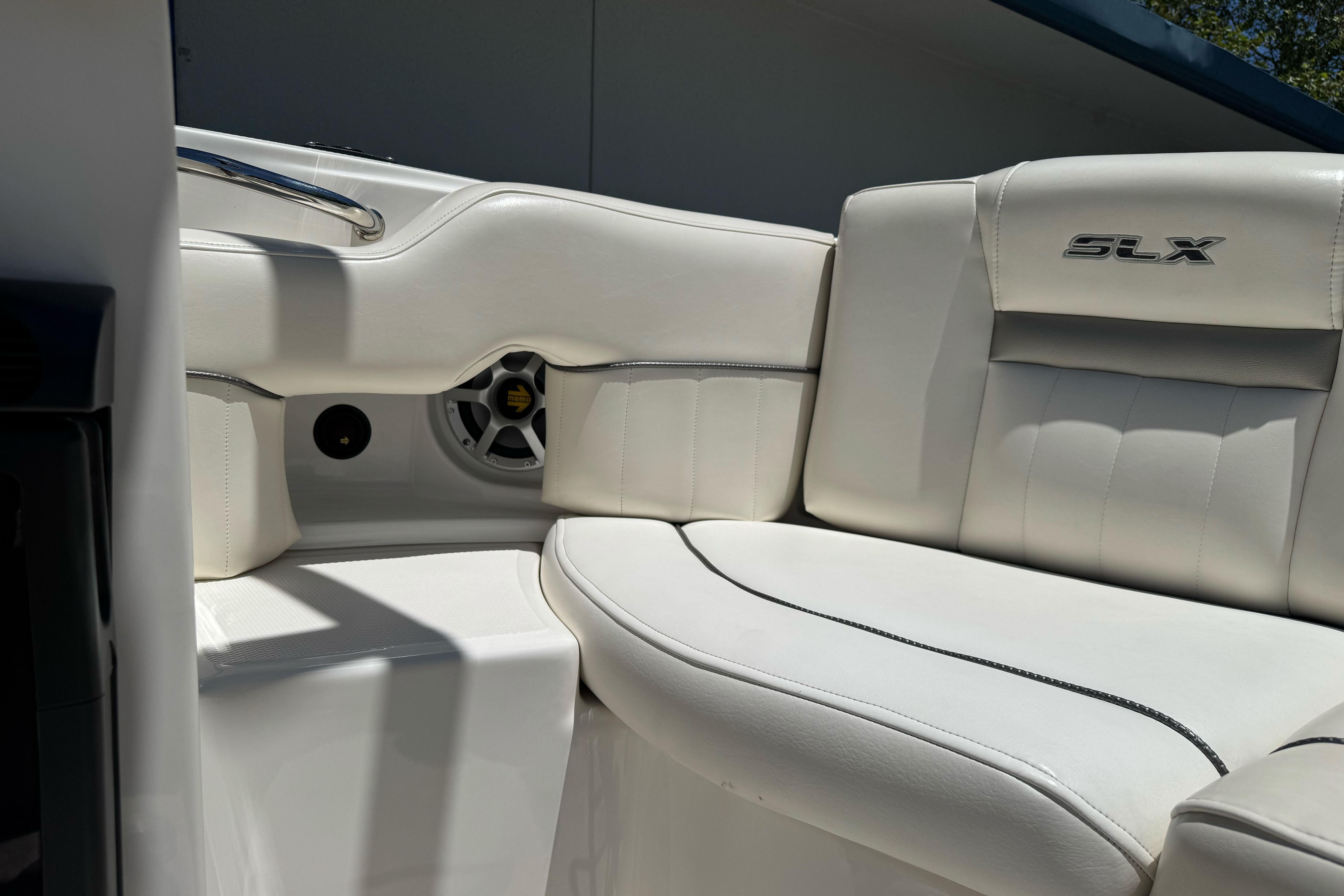 2007 Sea Ray SLX 250 boat interior with white leather seating and speaker detail.