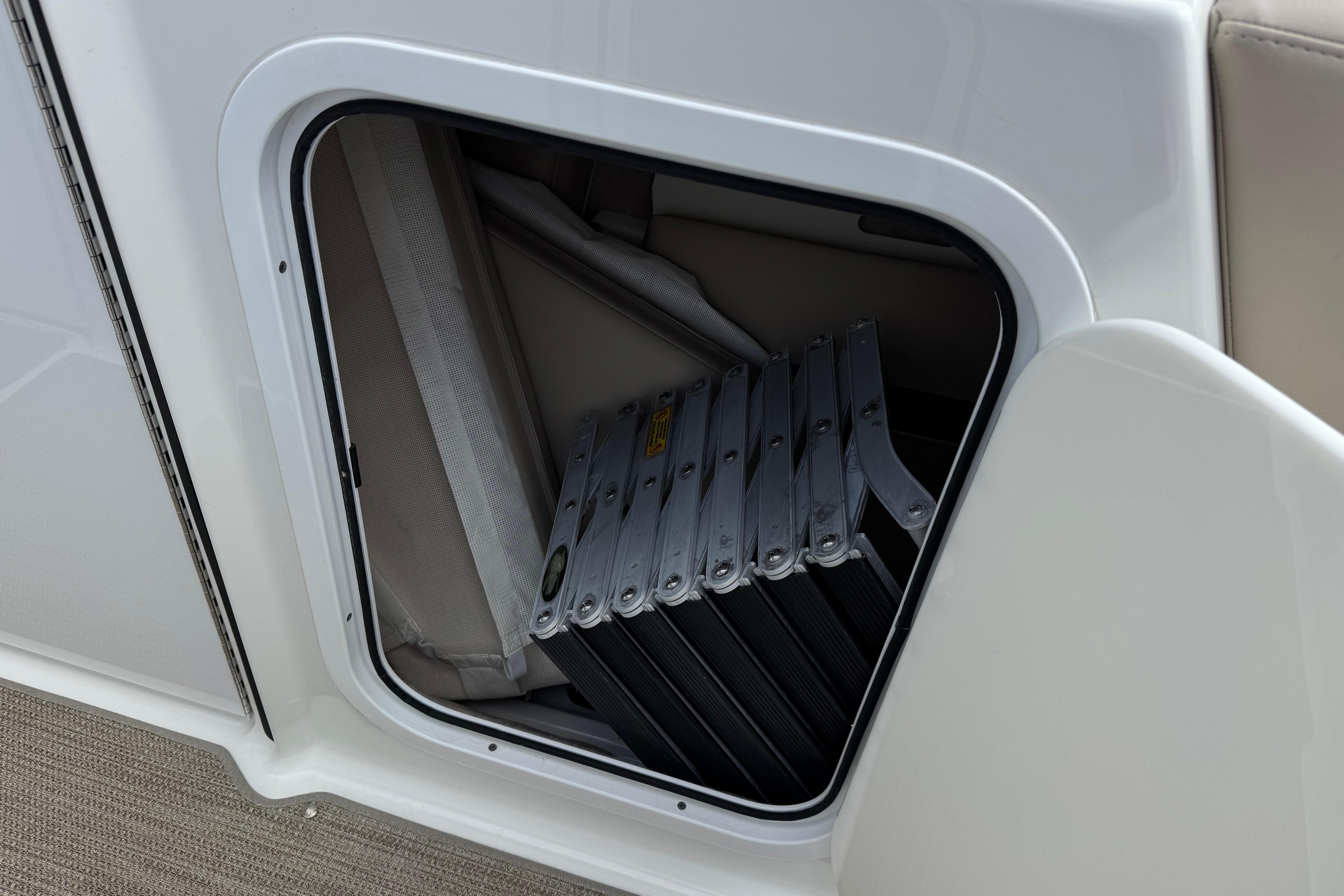 Storage compartment with folded ladder on 2016 Formula 350 Crossover Bowrider I/O boat.