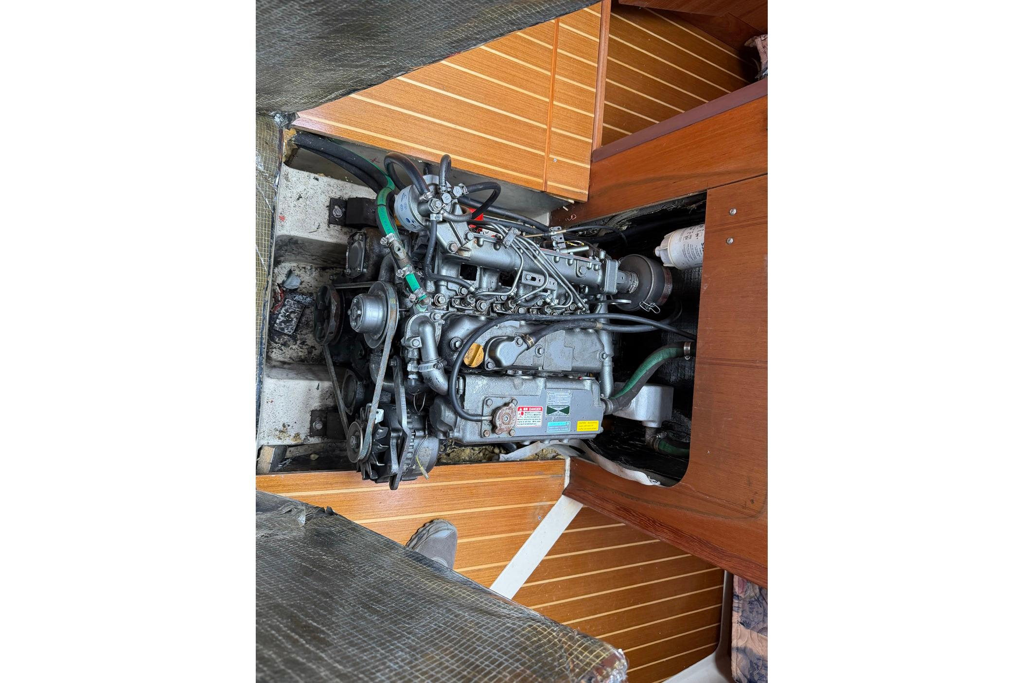 Engine compartment of a 1998 Hunter 410 sailboat, showcasing detailed mechanical components.