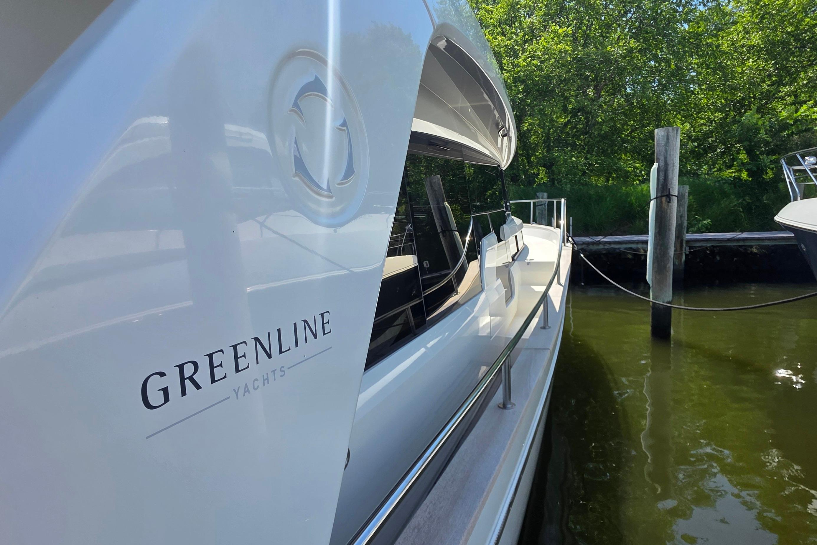 2023 Greenline 40 yacht docked, showcasing sleek design and branding.