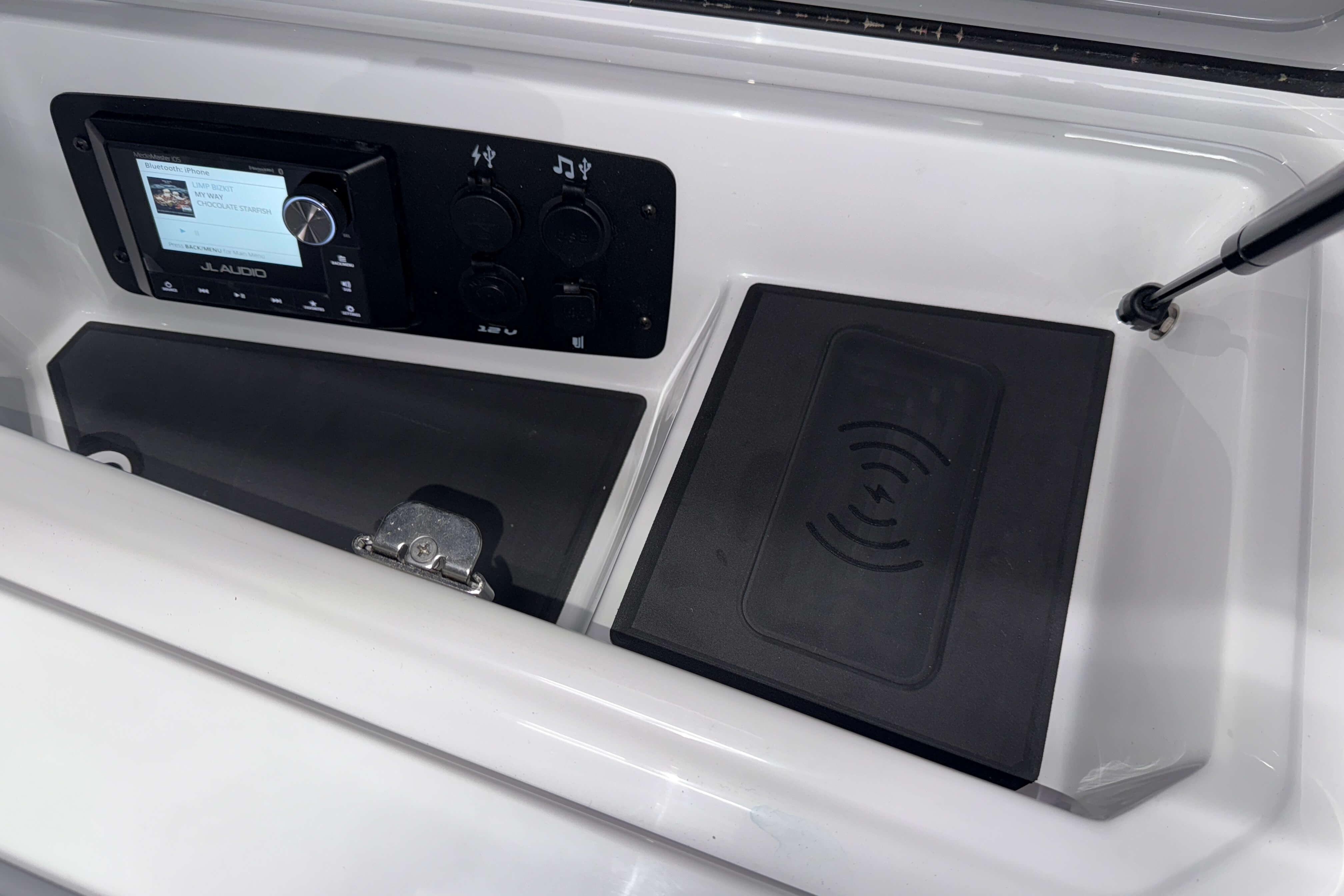 2026 Nautique Super Air Nautique GS22 dashboard with JL Audio system and wireless charging pad.