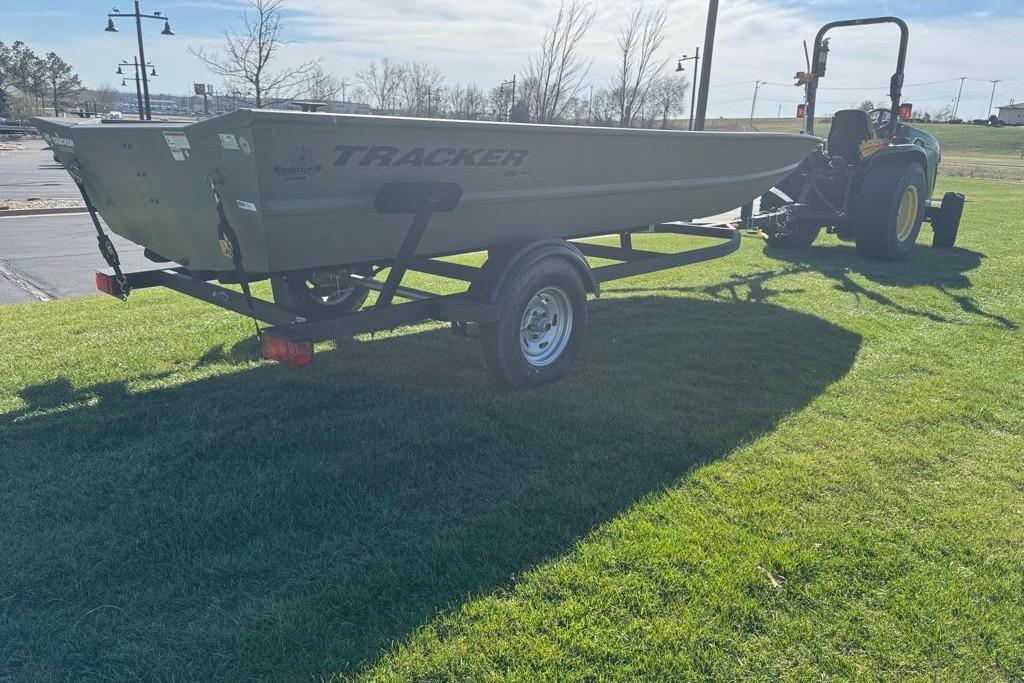 2026 Tracker Grizzly 1754 Utility boat on trailer, parked on grass, sunny day.
