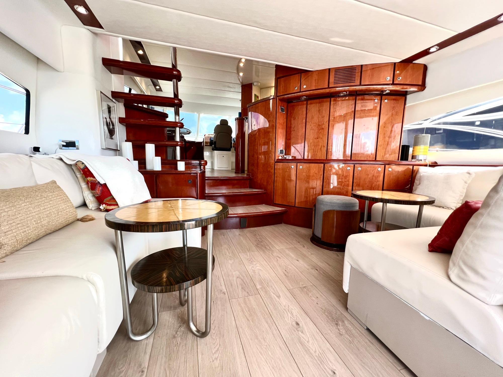 Luxurious interior of 1999 Fairline Squadron 65 yacht with modern furnishings and wooden accents.