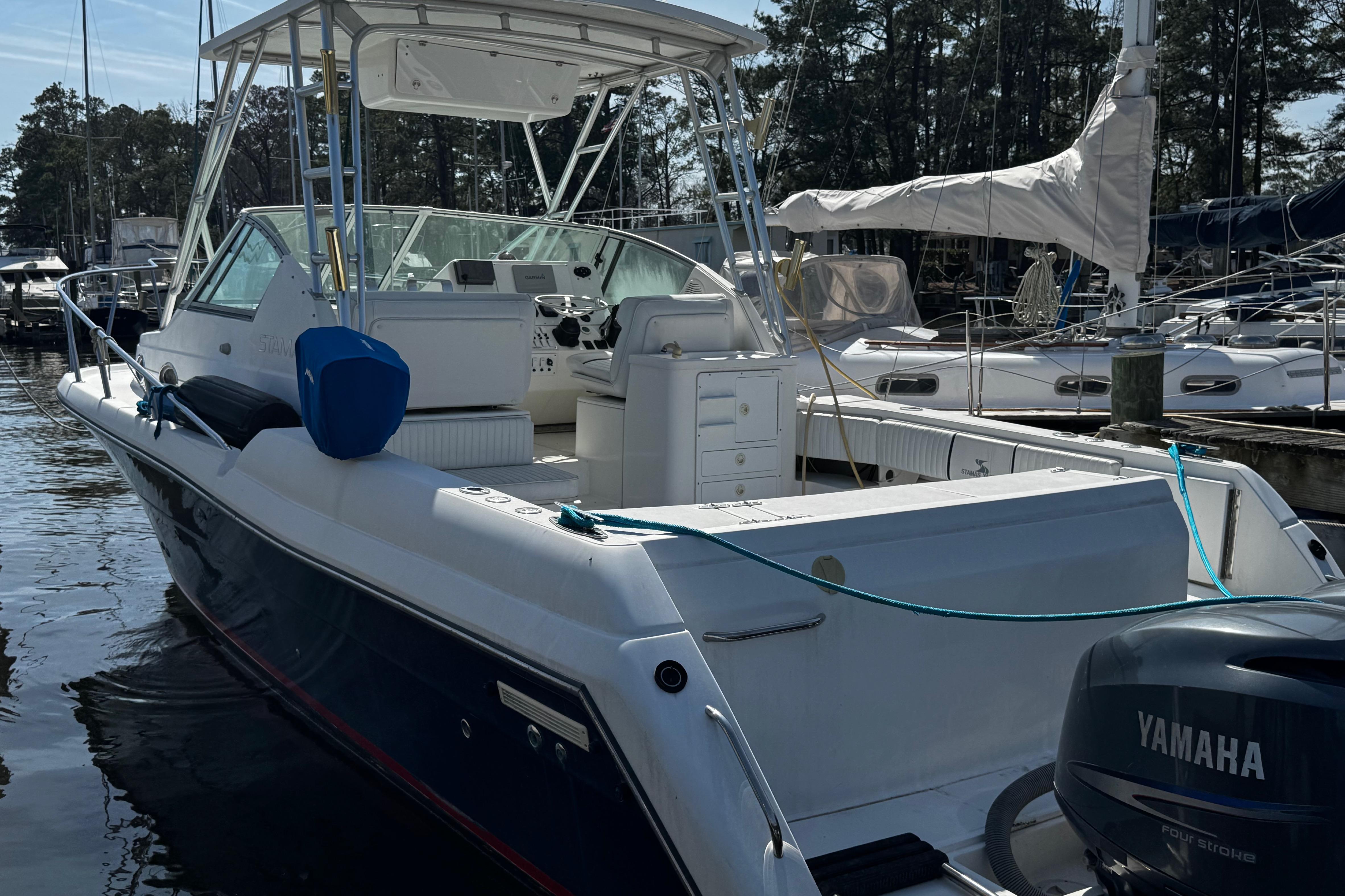 2001 Stamas 310 Express boat docked, featuring Yamaha outboard motor, in a marina setting.