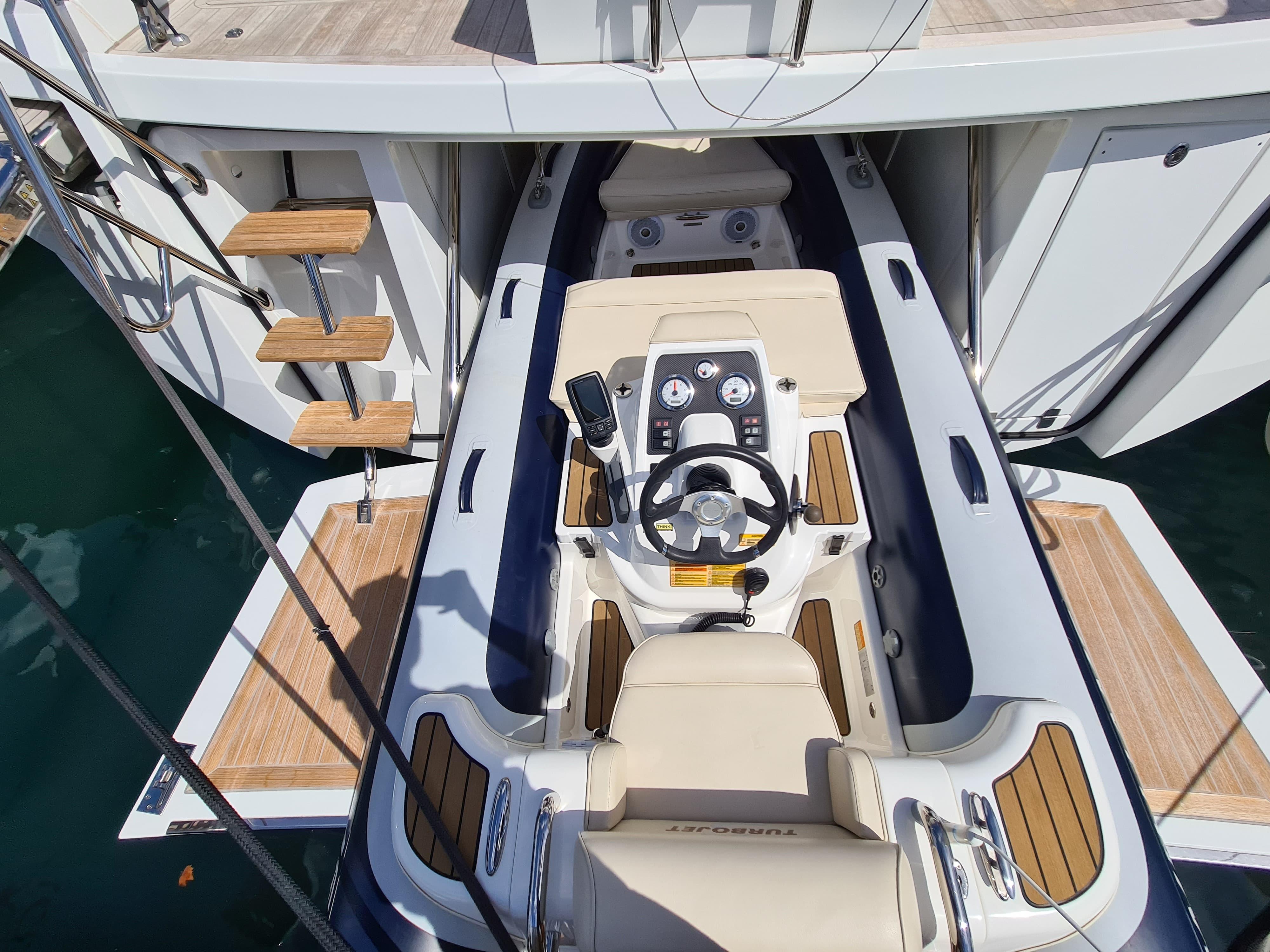 Luxury CNB 76 yacht's helm station with wooden accents, 2017 model.