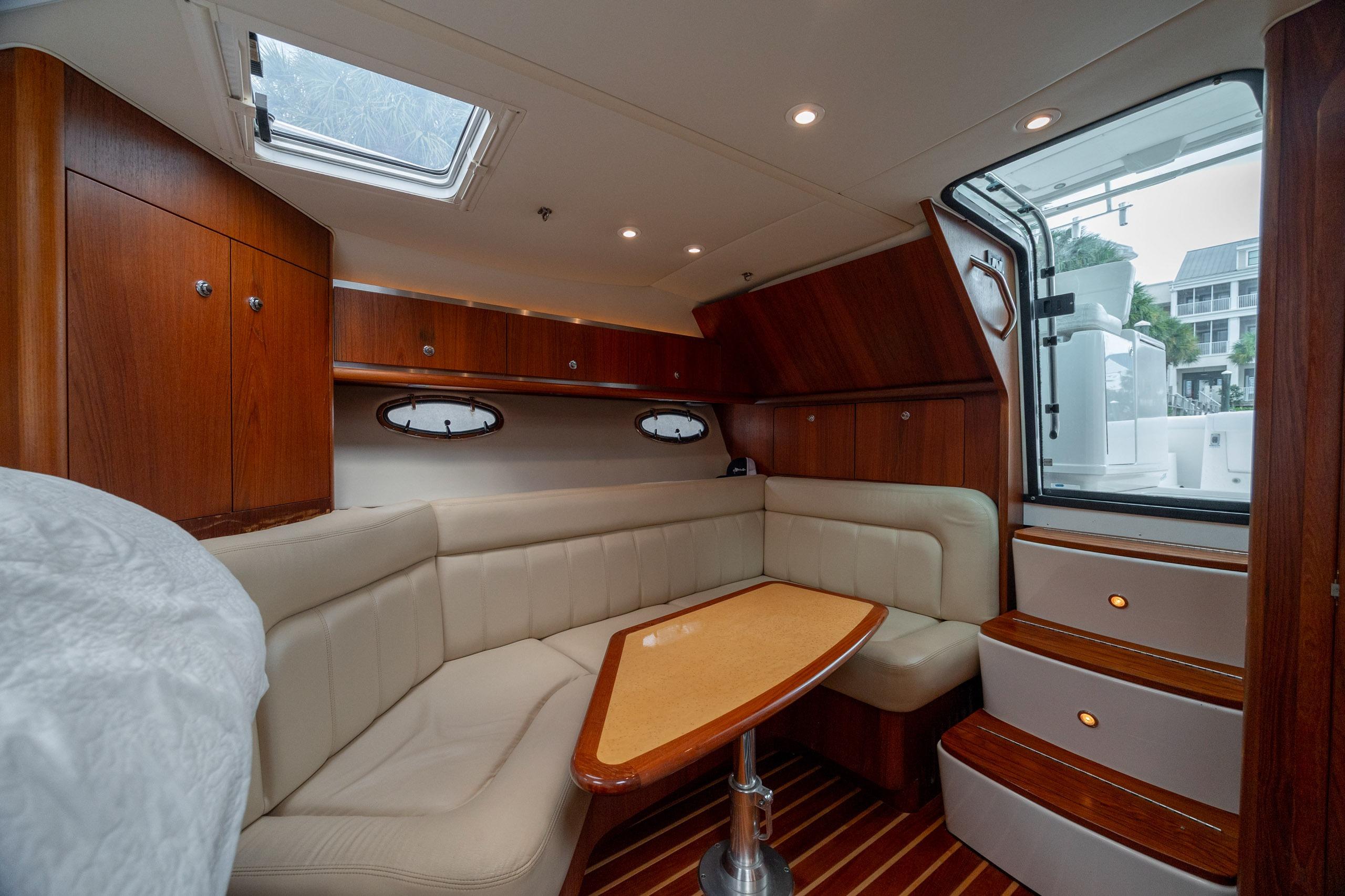 Luxurious interior of 2004 Tiara Yachts 3200 Open with elegant wood and leather seating.