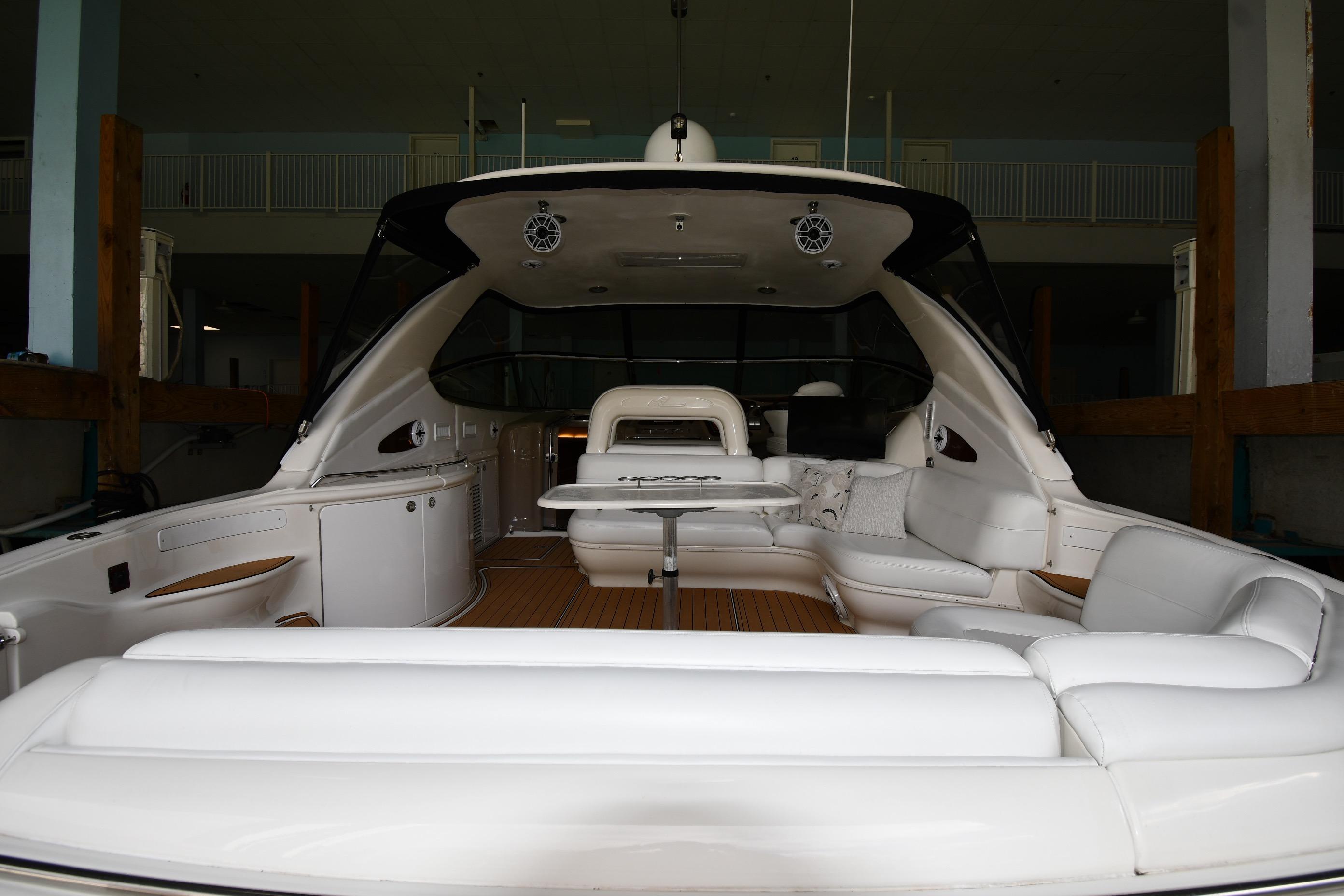 2001 Sea Ray 540 Sundancer yacht interior with white seating and wooden flooring.