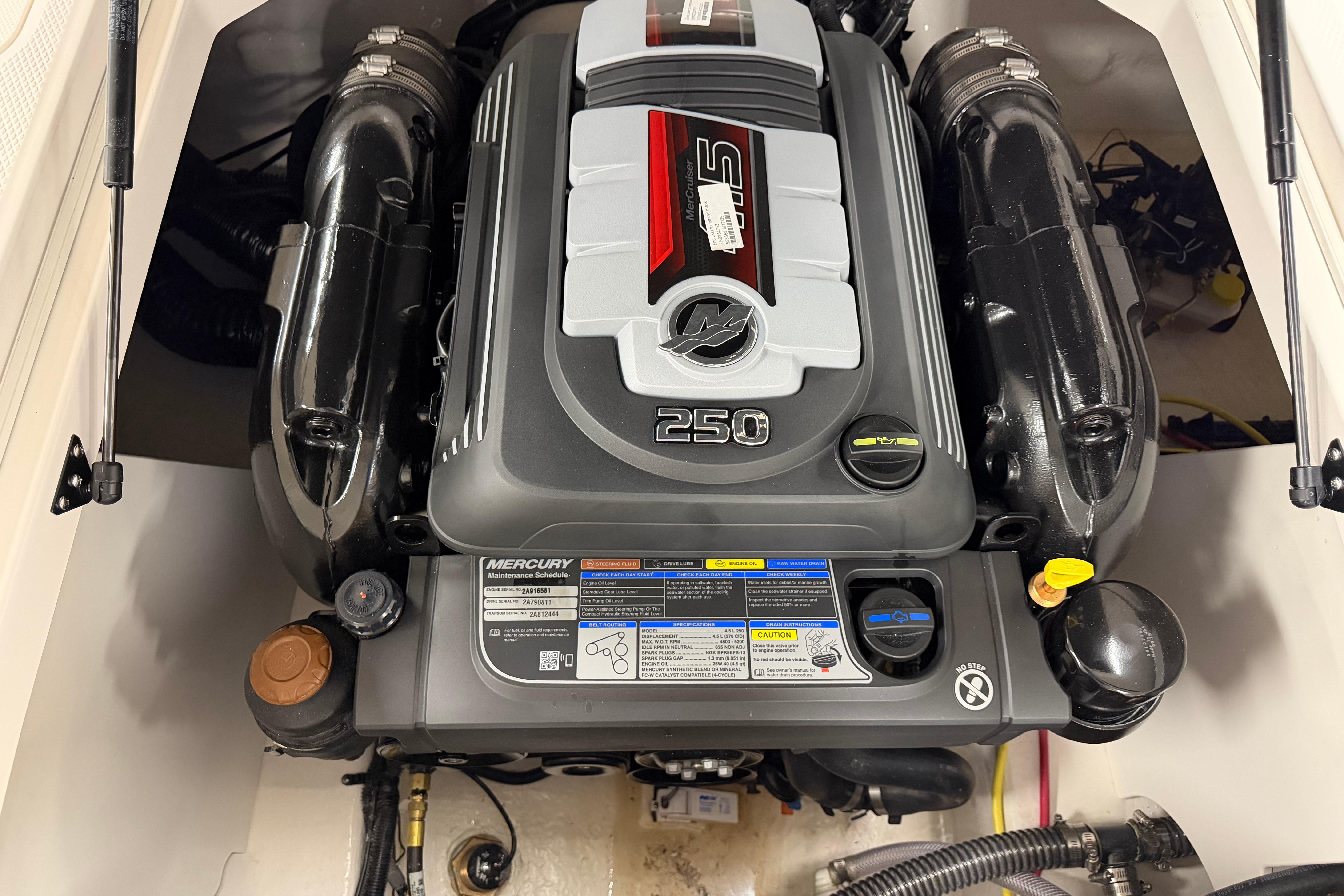 Engine compartment of 2026 Chaparral 21 SSi Ski & Fish boat, featuring Mercury 250 engine.