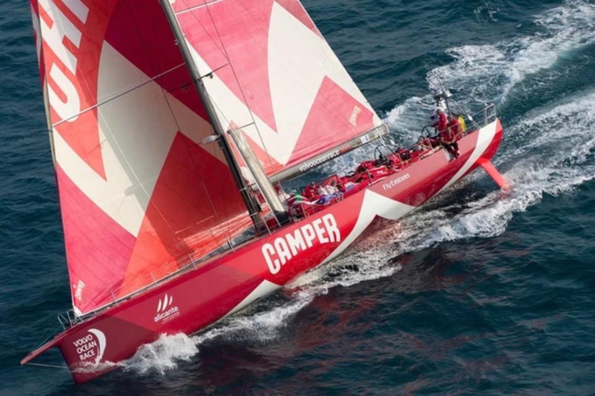 Red Volvo Ocean Race sailboat "Camper" navigating ocean waters, 2011.
