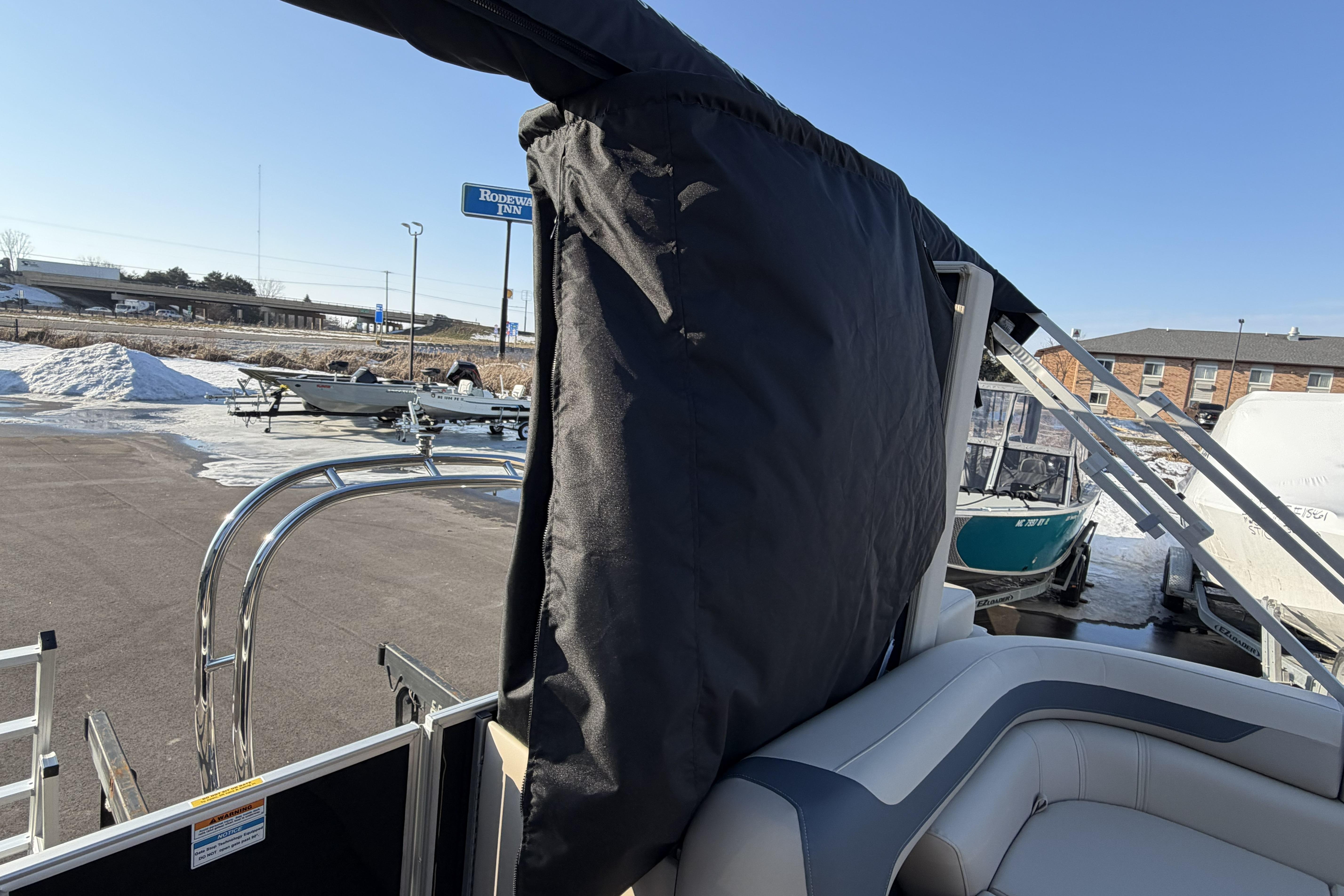 2026 Godfrey Sweetwater 2086 C pontoon boat with covered seating, parked in snowy lot.