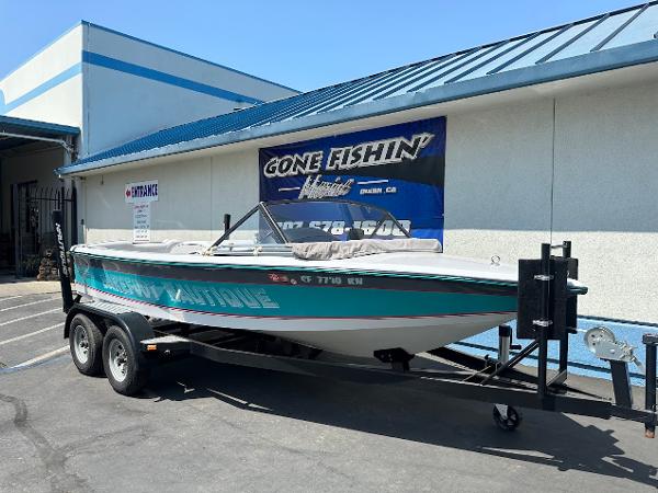 1992 Correct Craft Ski Nautique boat on trailer outside a building.