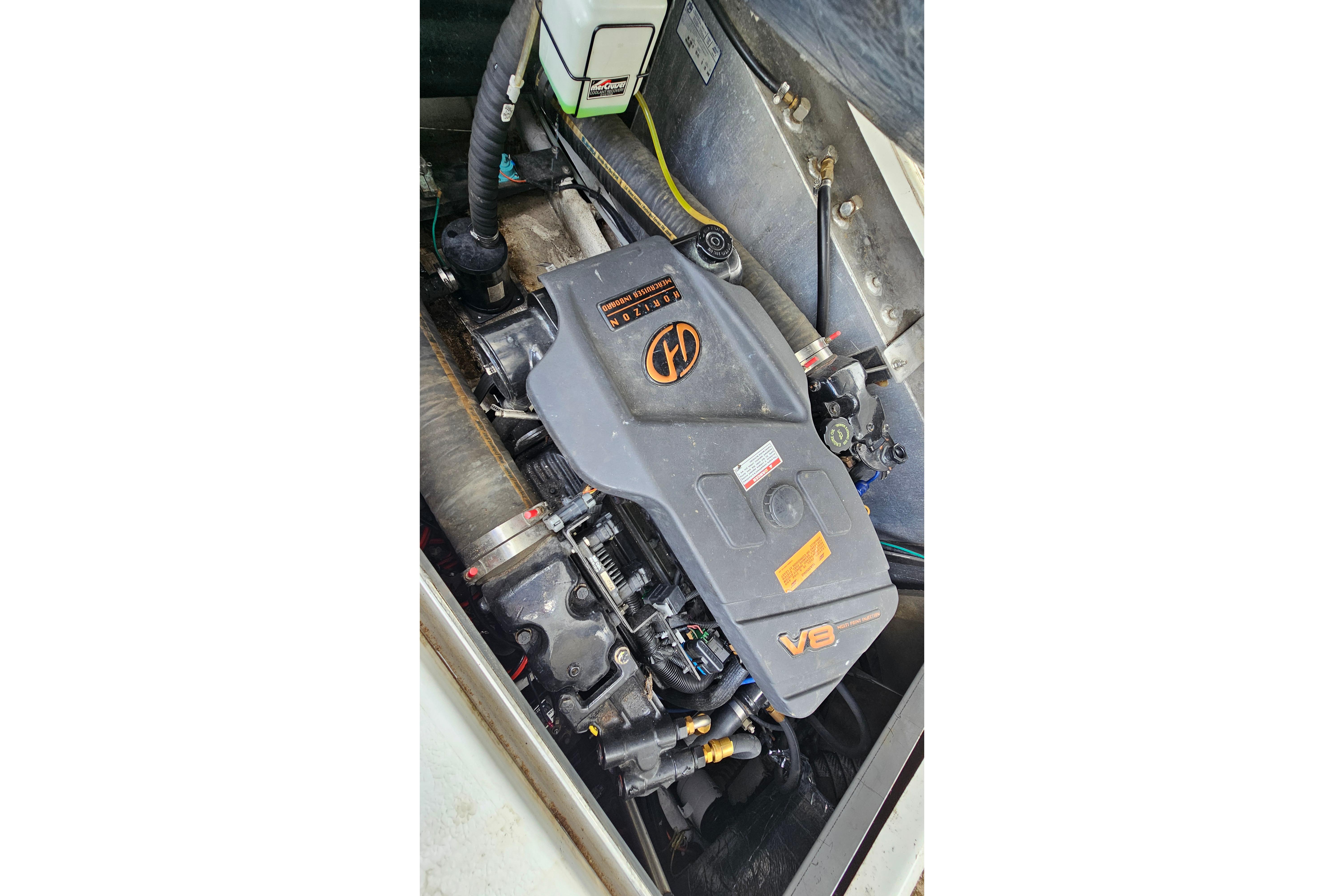 Engine compartment of a 1999 Carver 350 Mariner boat, featuring a V8 engine.