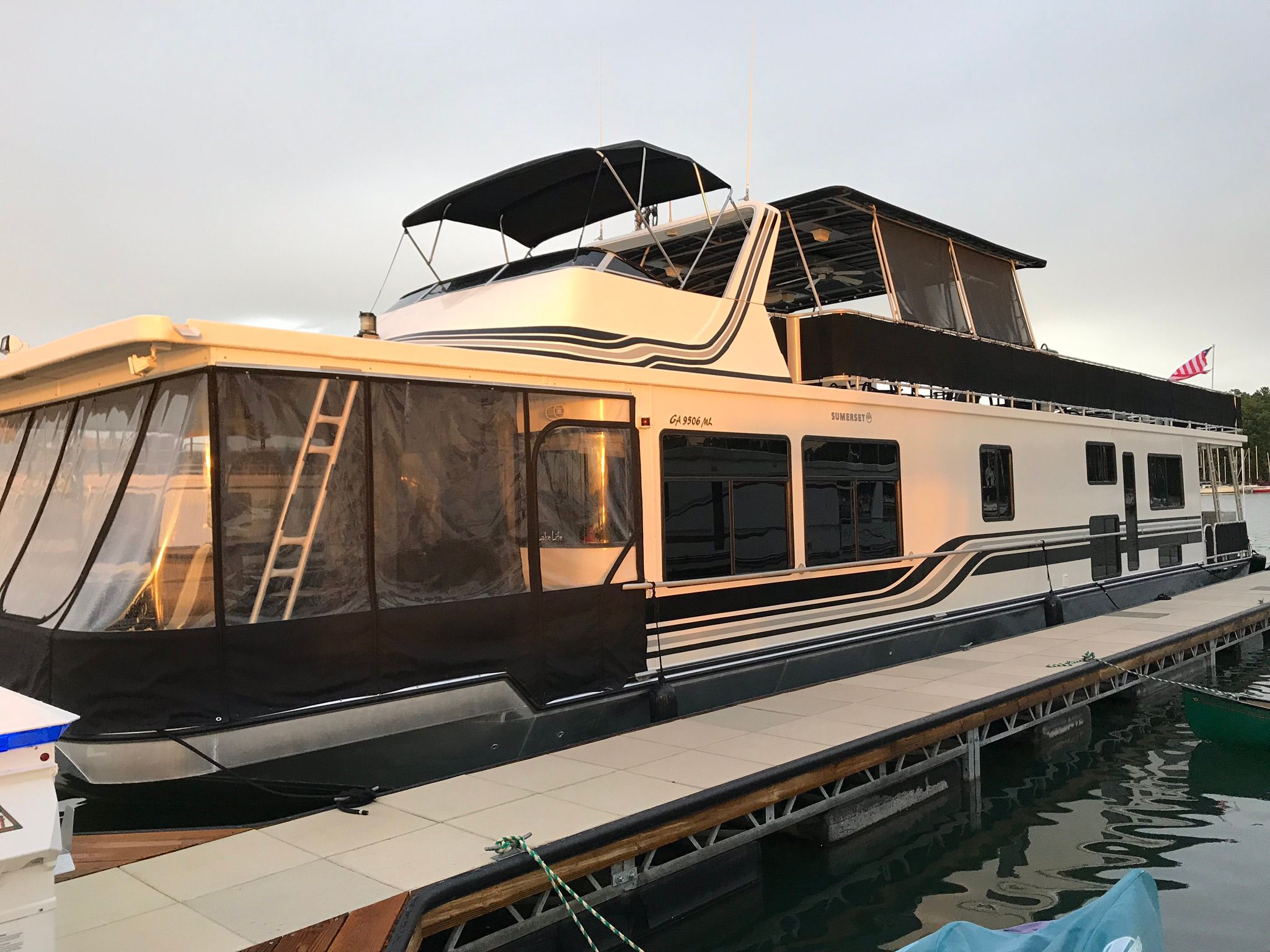 2001 Sumerset houseboat docked at sunset.