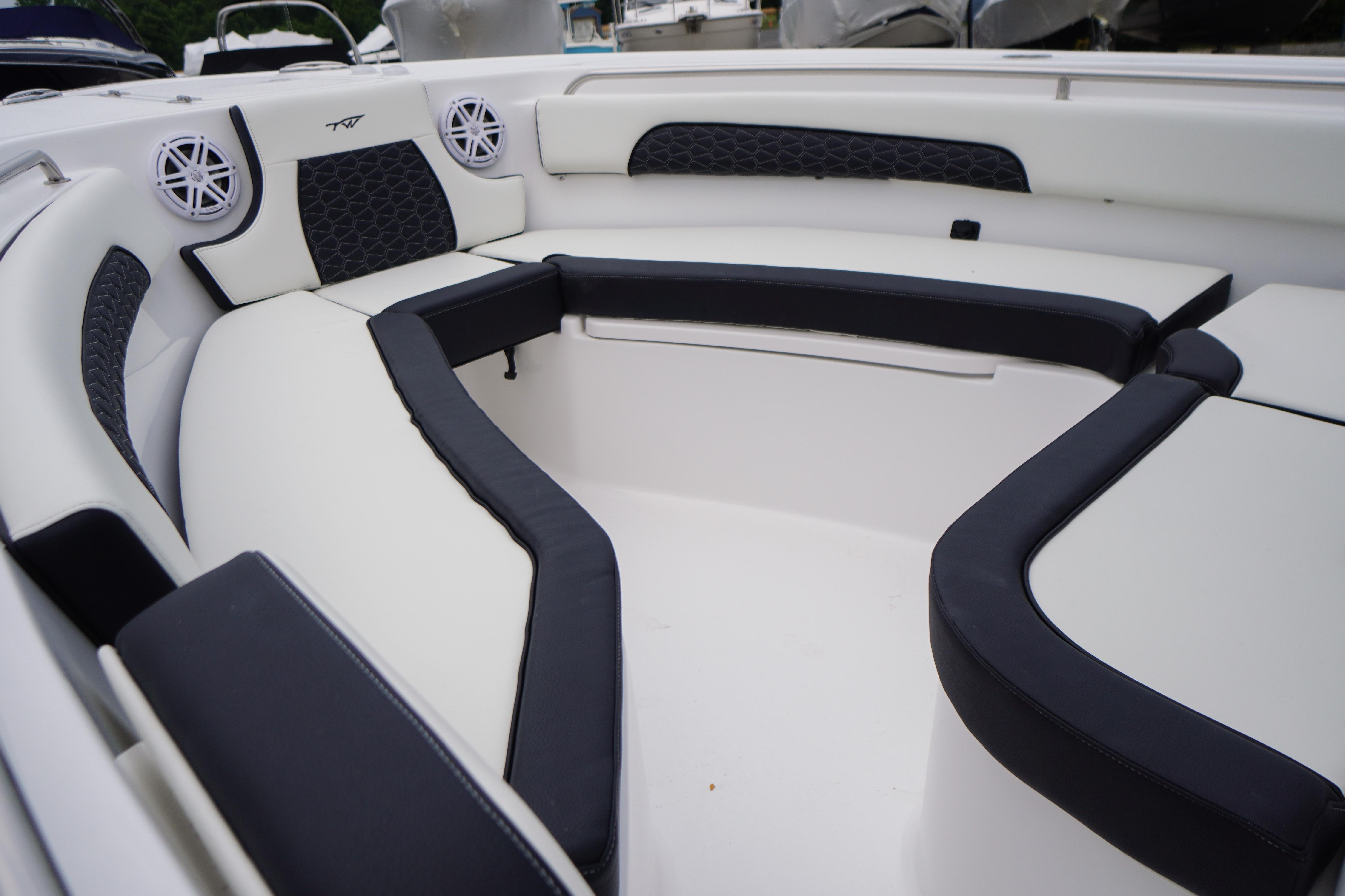 Interior view of 2026 Tidewater 232 SS boat with cushioned seating and speakers.