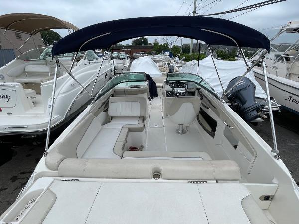 2013 Sea Ray 240 Sundeck boat with blue canopy, spacious seating, and sleek design.