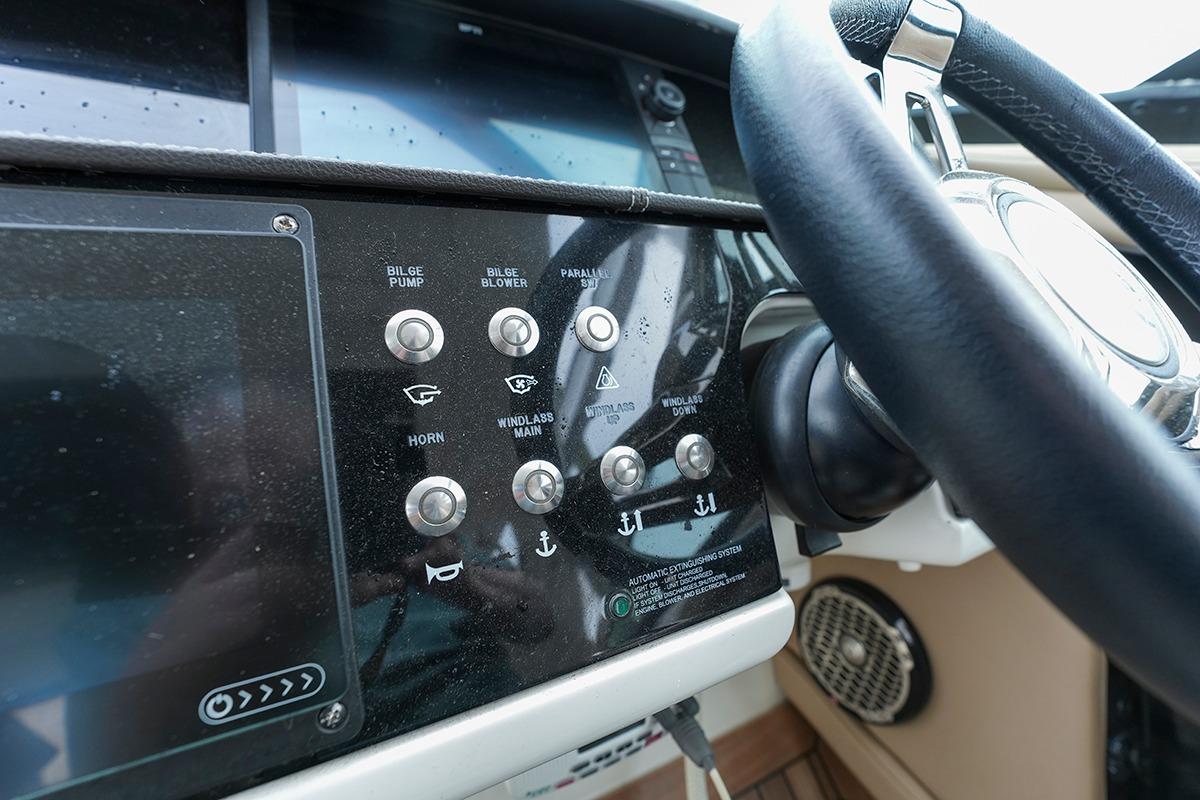 Control panel of a 2018 Sea Ray SLX 350 boat with steering wheel.